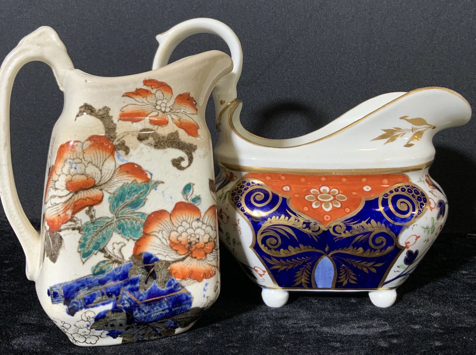 Lot 2 Signed Antique Porcelain Serving Pitchers: Possibly 19th century Mason’s Ironstone patterned serving vessels. Hand painted Colors throughout are white, saffron, cobalt blue, and gilt line work. Decorative gilt handle on one vessel. One handl