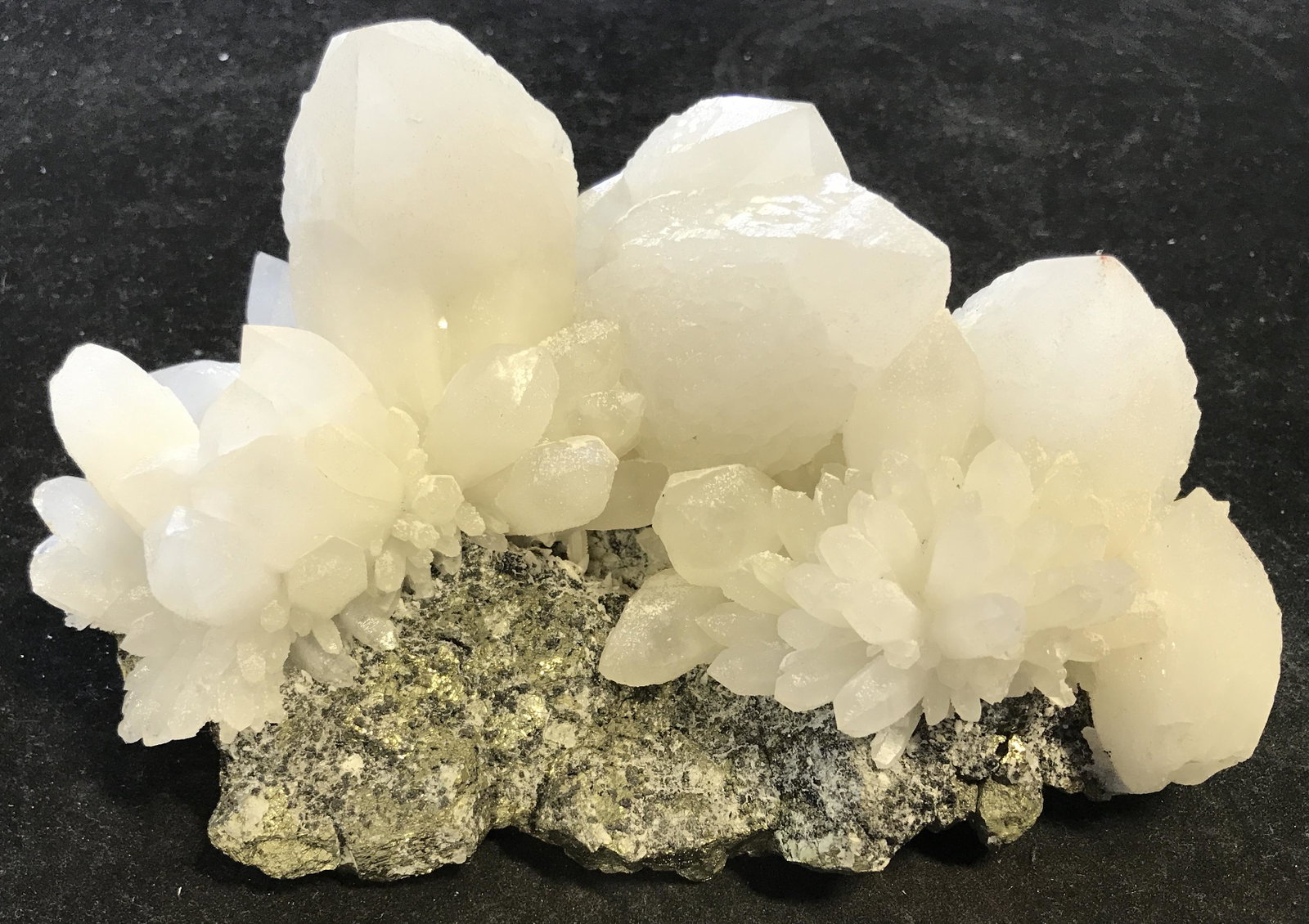 Peruvian Mined Pineapple Quartz on Pyrite: Peruvian mined Pineapple Quartz on Pyrite Crystal Cluster, unique in its own shape and size, a metallic black and gold colored gem with pale yellow and white stones sprouting from its facets, measures