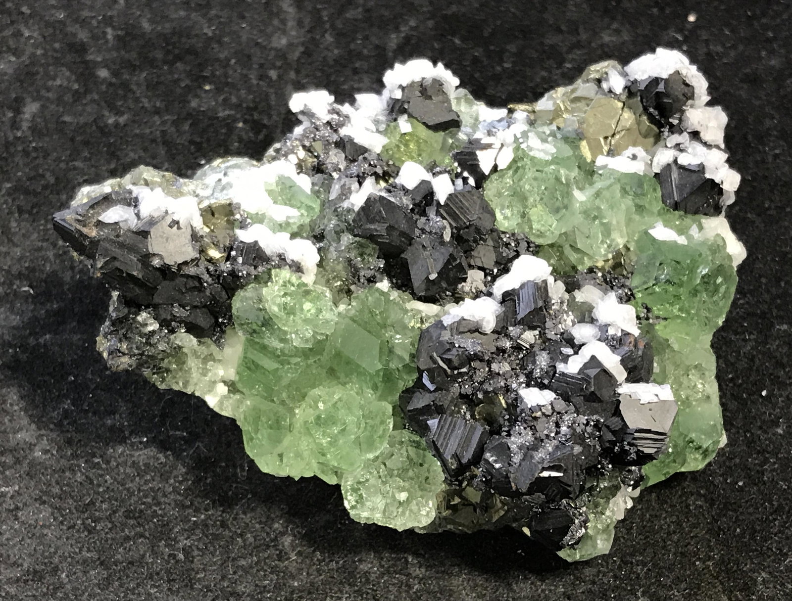 Peruvian Mined Fluorite & Sphalerite Cluster: Peruvian mined Fluorite and Sphalerite Crystal Cluster, mined from the Huanzala mine in Peru, unique in its own shape and size, a metallic black and gold colored gem with white and green colored gems 