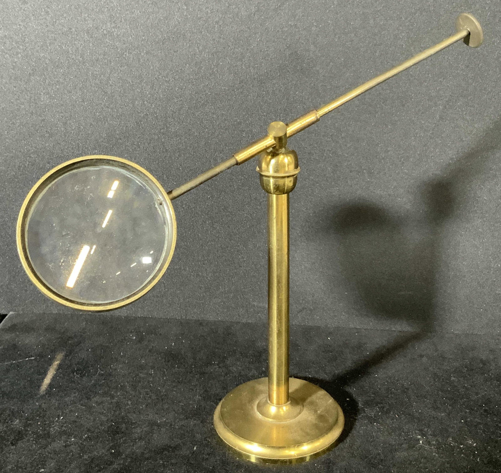 English Vintage Brass Standing Desk Magnifier: A brass adjustable standing desk magnifier. Rotates and moves about at ball joint. Glass is in good condition. Approx. length 9 in. Approx. height 6 in. Vintage collectibles, vintage magnifying glass,