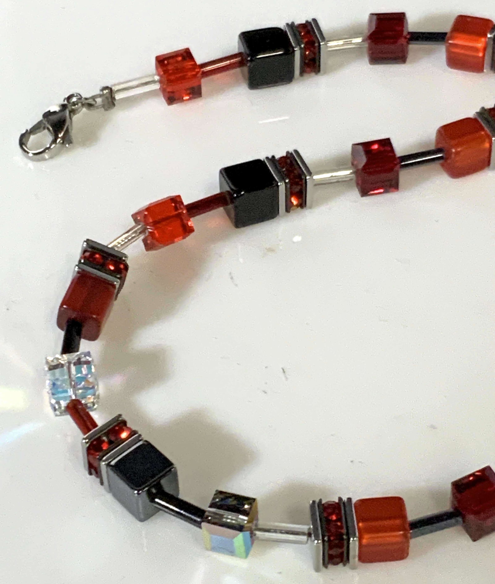 GERMAN BLACK FOREST SS Crystal Bead Necklace: Sterling silver vintage Black Forrest crystal necklace made in Germany. Beading is squared. Red, black, and silver hues. Lobster clasp fastens necklace, adjustable. Near clasp are letters: OE. No othe