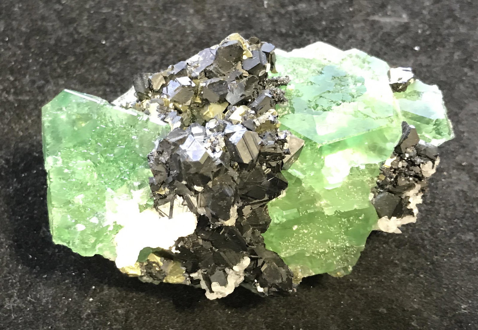 Peruvian Mined Fluorite & Sphalerite Cluster: Peruvian mined Fluorite and Sphalerite Crystal Cluster, mined from the Huanzala mine in Peru, unique in its own shape and size, a metallic black and gold colored gem with white and green colored gems 