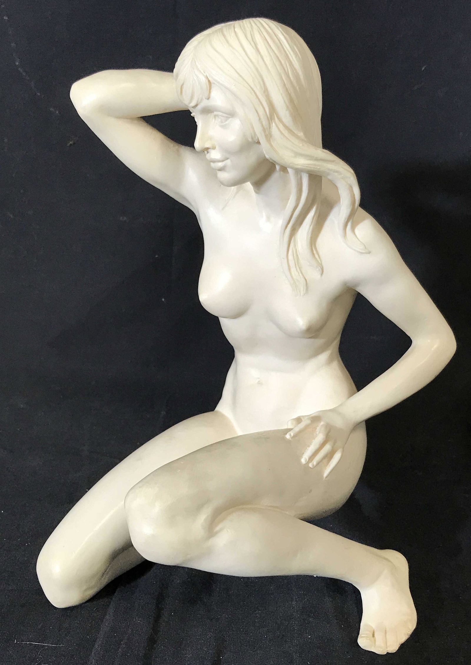 Composite Female Art Nude Tabletop Sculpture: Composite Female a Nude Tabletop statue, no apparent signatures or stamps, subject a nude female seated with a hand in her hair, piece completely white in color, measures 10 inches at tallest and 7 in