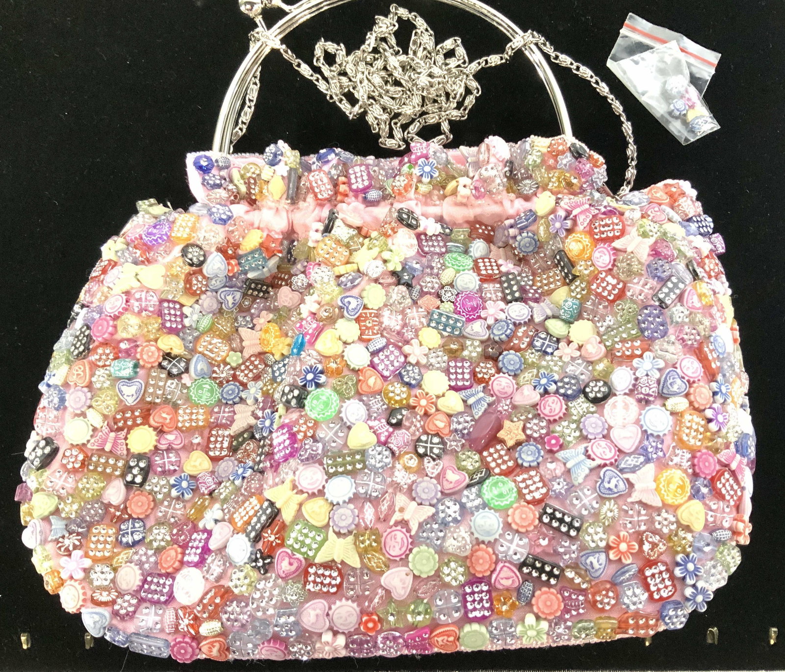 Handmade Pink Crystal Bead Purse, Paris: This purse is a hand bag with rounded chrome handles w/ 3 in drop and large ball kiss clasp. It also functions as a cross body bag with a silver toned 23 in drop chain that tucks inside bag. Intricate