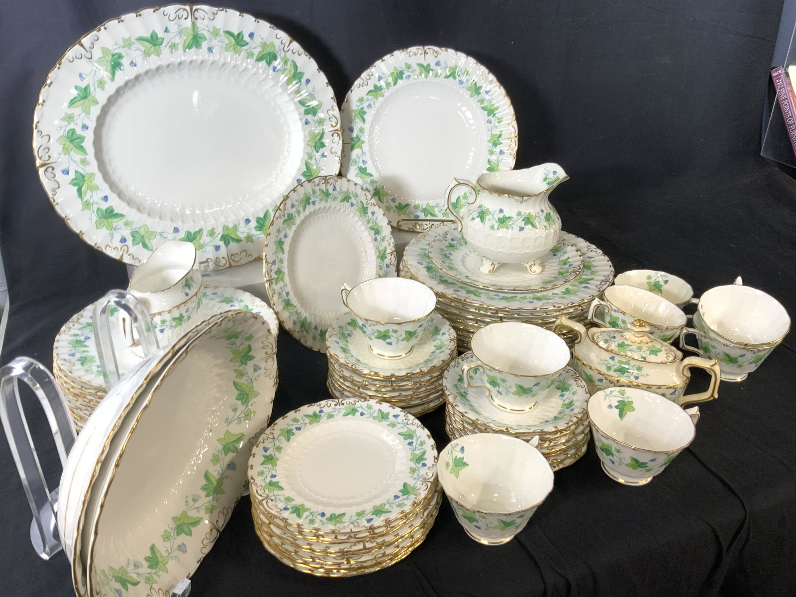 Set 63 ROYAL CROWN DERBY Chinaware, England: White porcelain dinnerware with gilt rims and green ivy with blue florals, called Medway (Burford) by Royal Crown Derby. Pieces include Victorian embossed inner pattern And signed numbered dishes. All