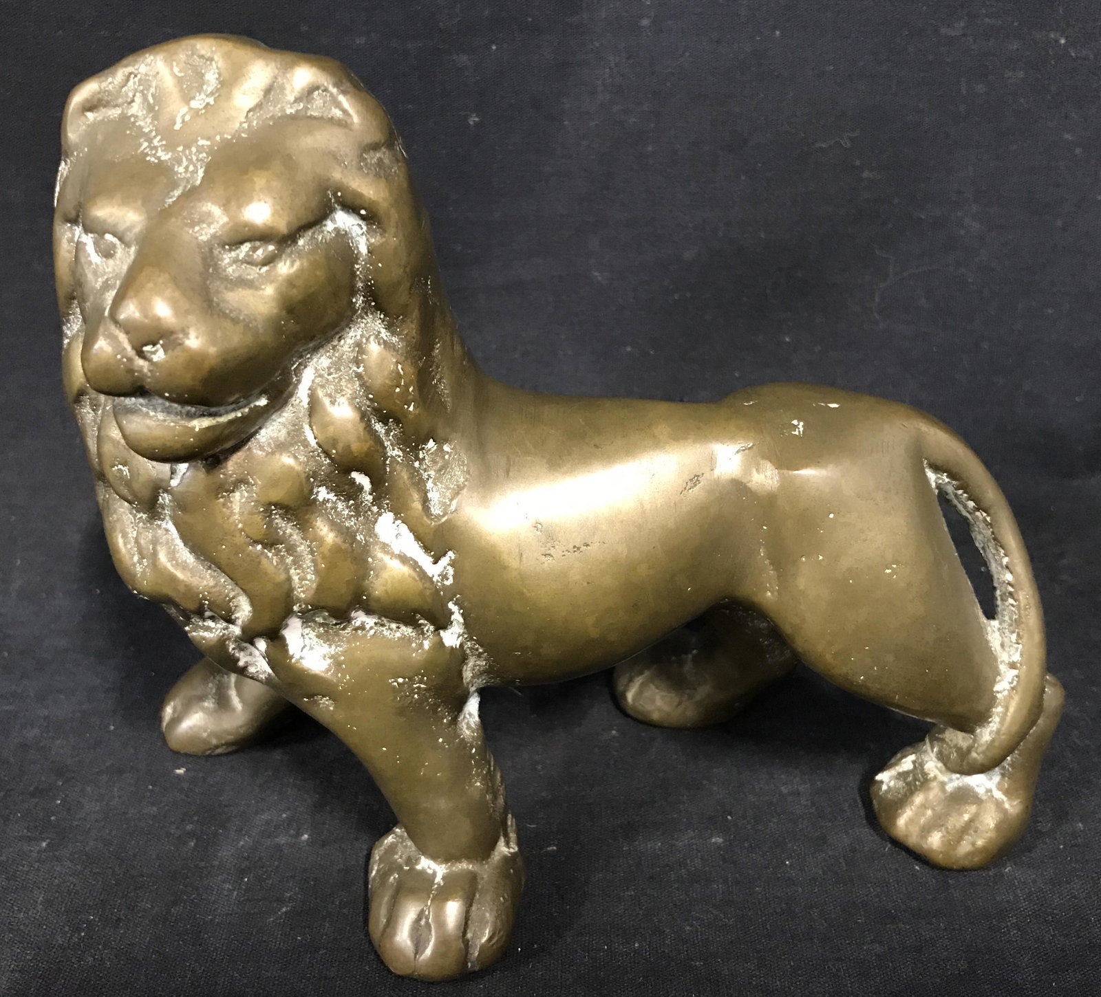 Solid Brass Lion Figural: Solid brass, possibly gilded iron Figural. Has significant weight. Measures approx 5.5 inches H, and 7 inches W. Wear is consistent with age, a patina has developed. Lions, big cat, iron working, meta