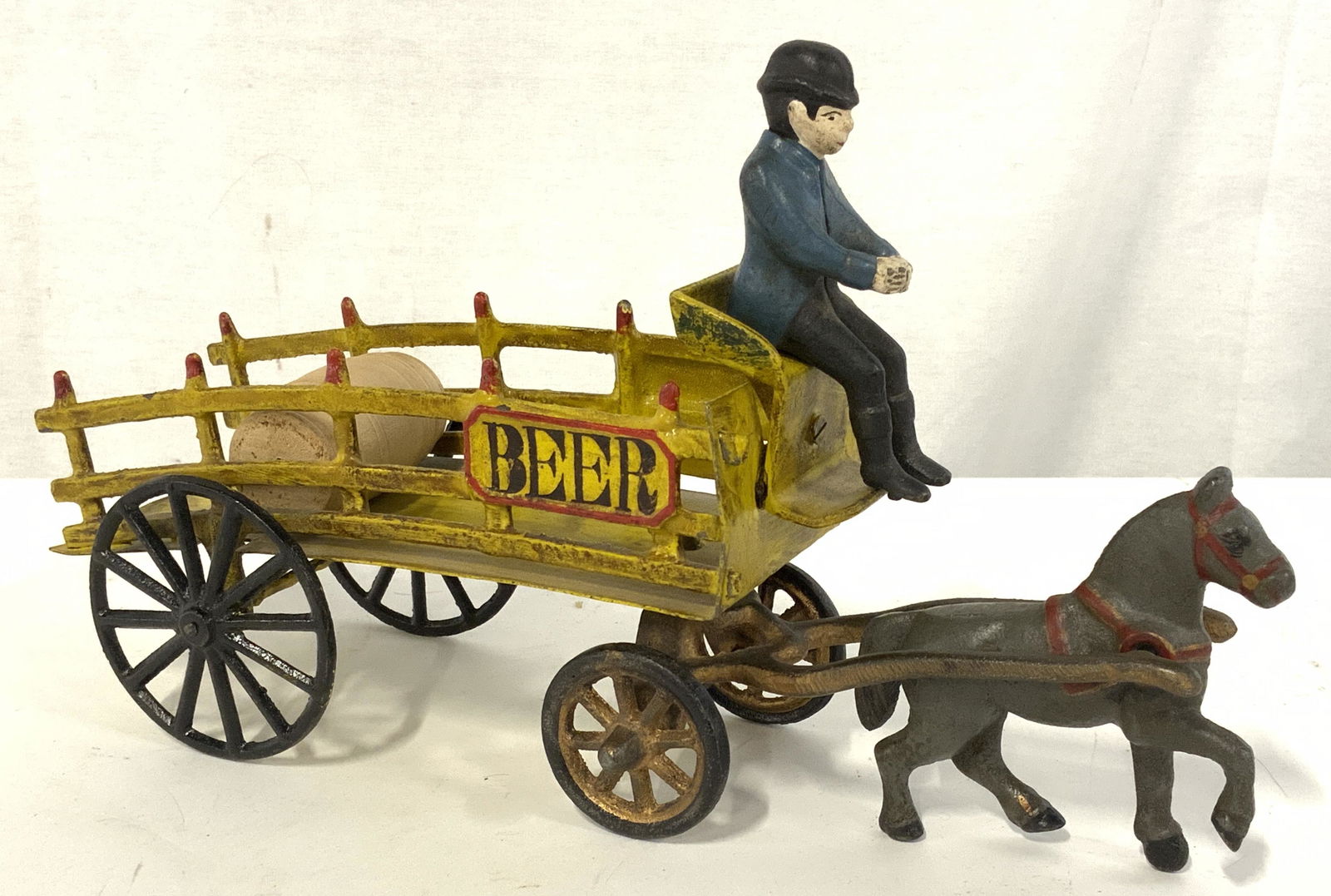 Collectible Cast Iron FOLK ART Beer Wagon Figural: Vintage piece, possibly antique, of painted iron BEER WAGON, WOOD BARREL On wagon, man sitting in front directing horse. Impressed info on Metal illegible. Horse and front wheels detach and swivels. 1