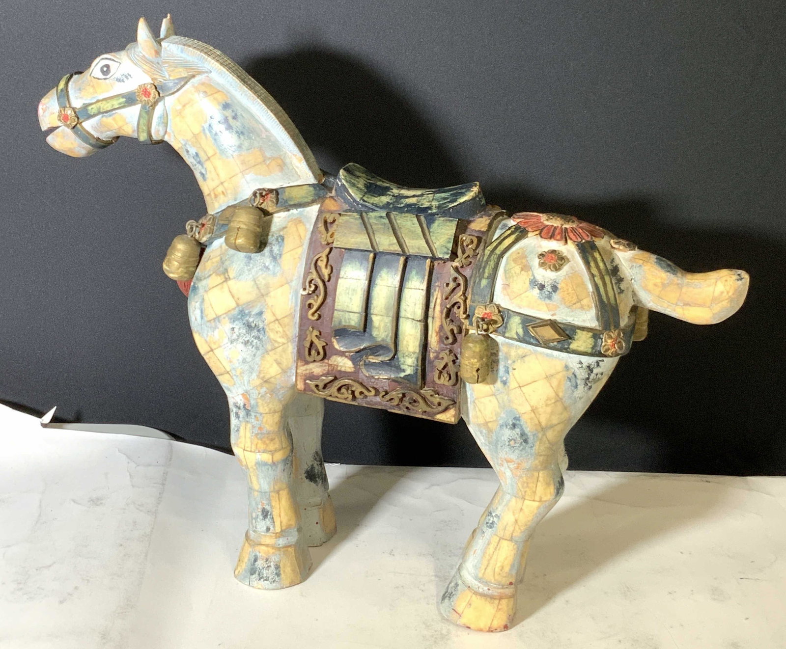 Folk Art Vintg. Carved Wood & Ceramic Horse Statue: A vintage carved wooden & ceramic horse with painted, possibly alabaster, tiles along itÂ’s form. Decorative hand carved wooden bobbles adorn the saddle and bridal. Metal fastenings hold the bobble