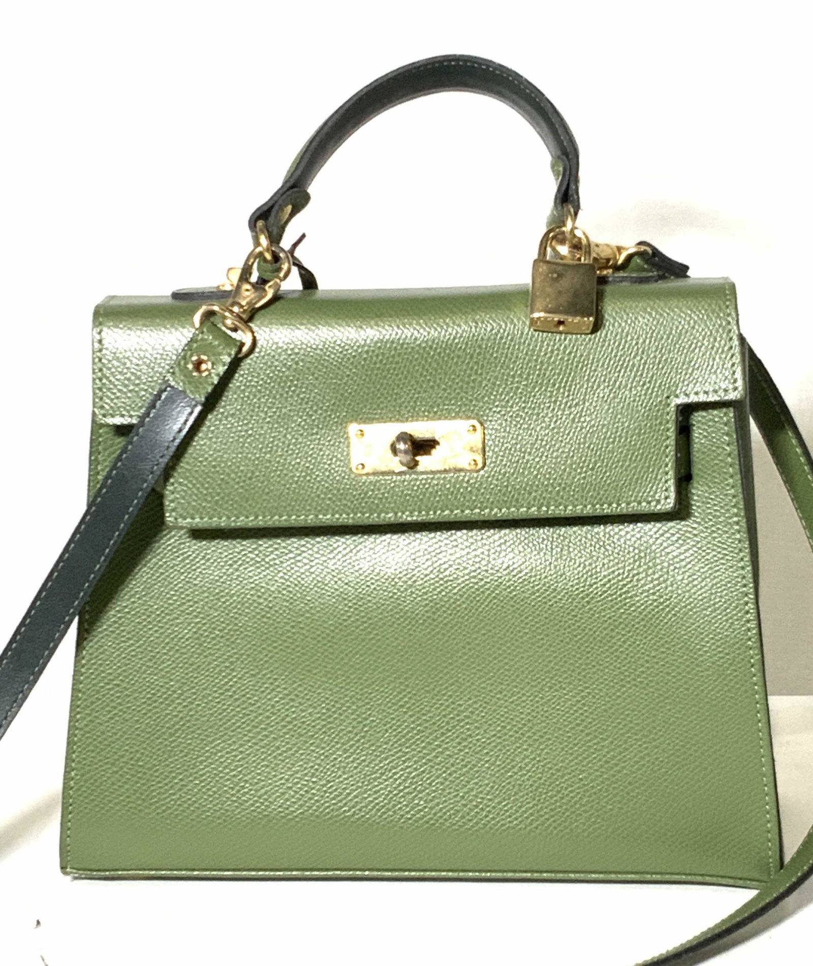 FOCUS Green Leather Purse, France: Green leather square shaped purse. Gold tone hardware throughout. A small metal polished gold tone lock shaped bobble hangs from the base of strap. Turn key closure. Strap is long, can be detached via