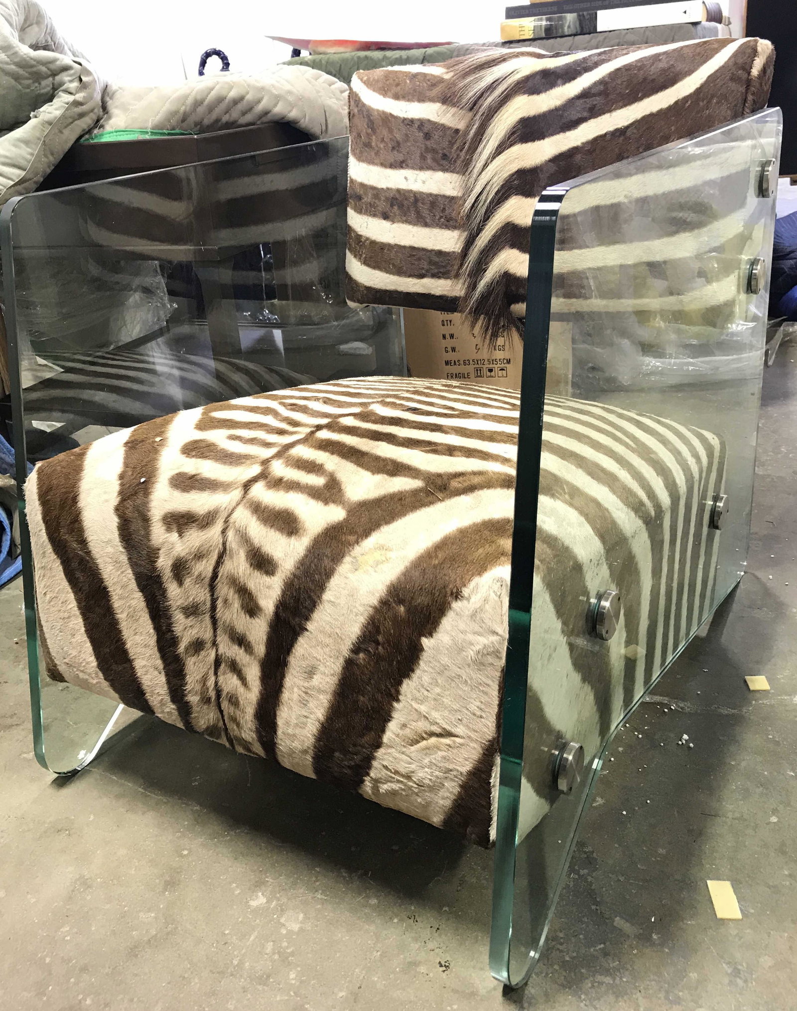 Custom Animal Hide Glass Arm Chair: Chair appears to be custom made. Chair has animal Hyde upholstery Possibly zebra. With brown & cream tones. Side of chair are thick walled glass. Measures approximately 29 tall 23 inches wide 34 inche