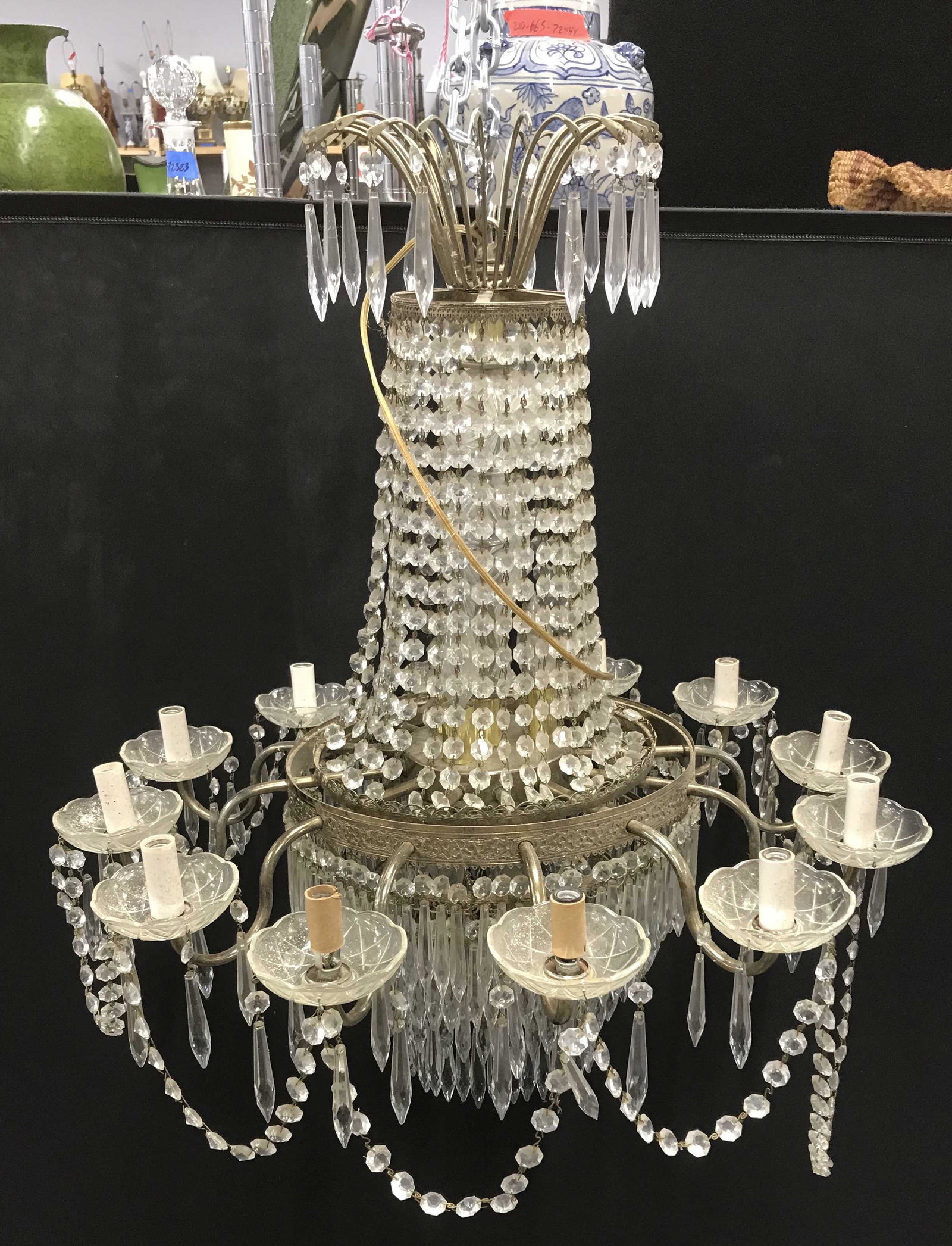 Antique Crystal & Brass Chandelier: Antique chandelier, possibly vintage. Etched detailing in brass, multi armed. Tiers of hanging crystals. 32 inches H, 29 inches in diameter. Wear is consistent with age and use. Some crystals have com