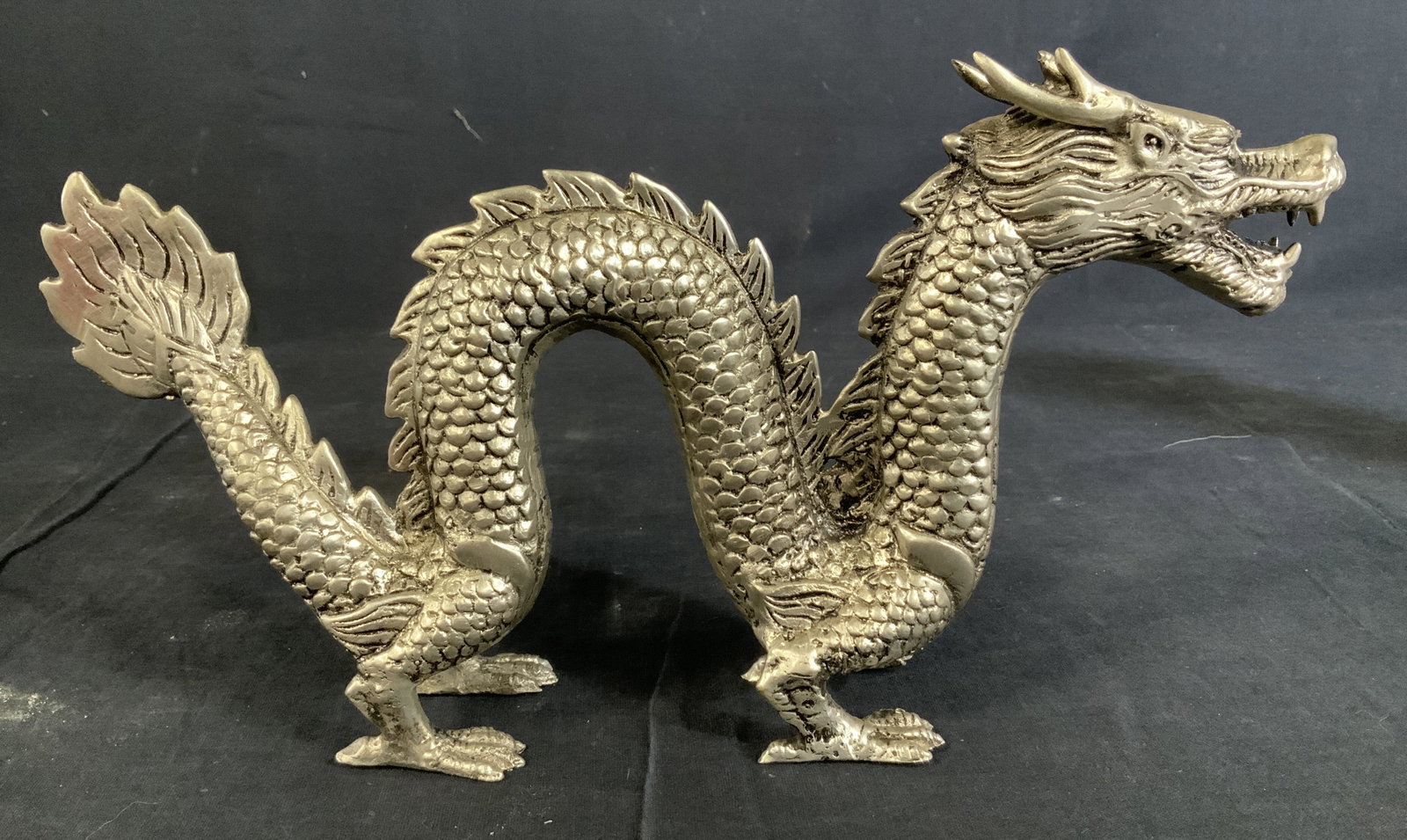 Asian Style Metal Dragon Sculpture: Asian Style Metal Dragon Sculpture, no apparent inscriptions or stamps, subject a standing dragon, measures 6 1/2 inches at tallest point x 11 3/4 inches at widest point, in good condition, Dragon, sc