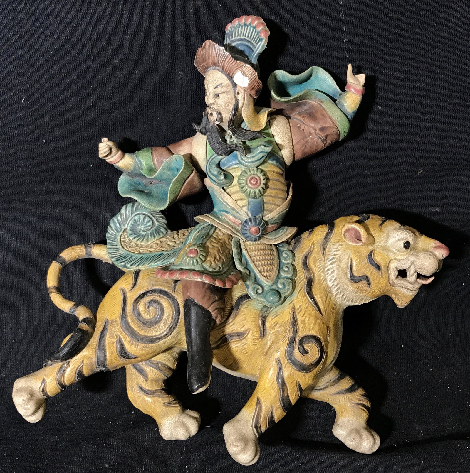 Chinese Ceramic Sculpture Man Riding Tiger: Chinese ceramic sculpture of a man riding a tiger, no apparent signatures or stamps, subject a man in traditional Chinese armor seated atop a tiger with arms extended, some chips to piece overall in g