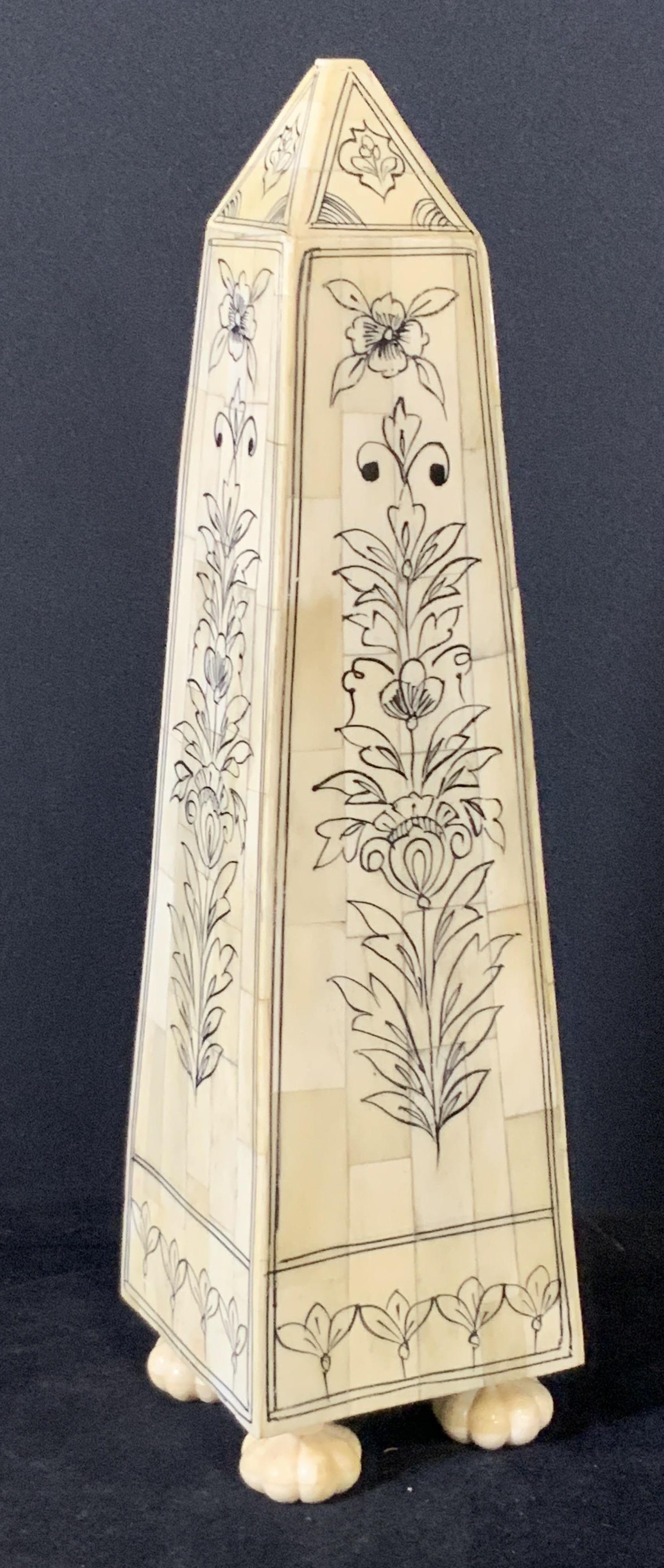 VAMA Hand Painted Bone Tile Obelisk: Hand Painted bone tile obelisk. Black floral designs throughout piece. Florette style feet (4). Top is flattened. Underside sticker is partially worn off, reads: Vama, 465. Approx. Height 13 in. Appro