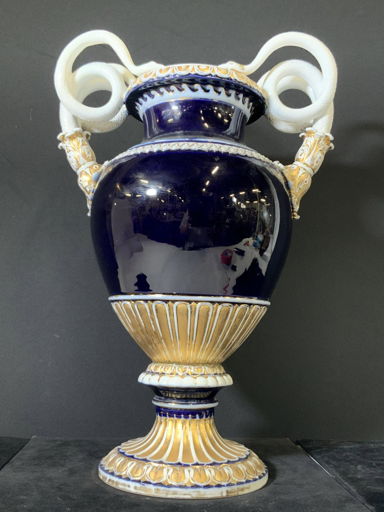MEISSEN 19th Century Porcelain Cobalt Snake Vase: Circa 19th century large porcelain cobalt blue urn vase. Twin white porcelain snake handle vase with embossed scales and gilt line work. The top spins against the bottom. Underside interior has metal 