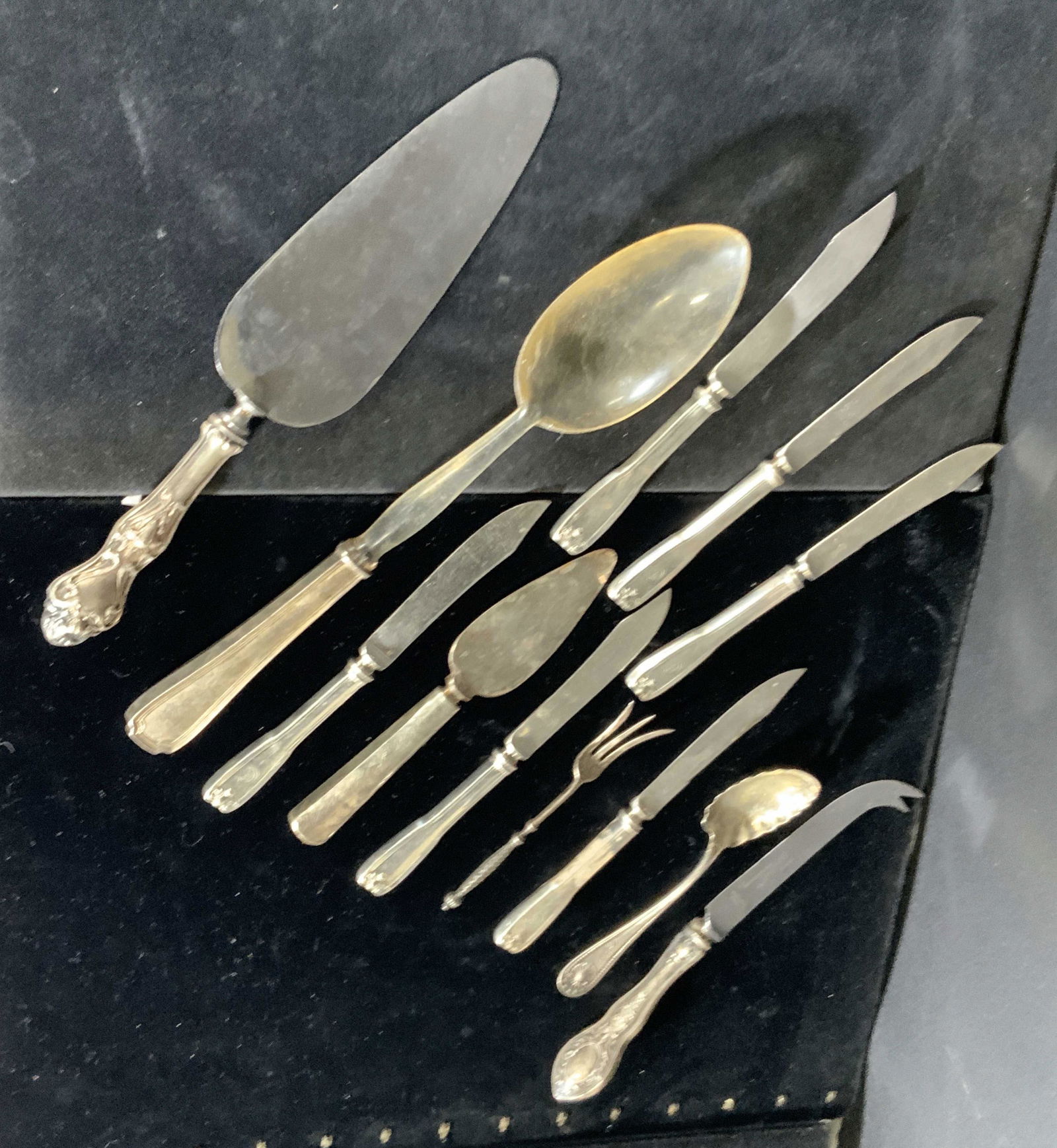 Lot 12 Kitchen Utensils, Sterling silver and more: 7 knives, 2 spoons, 1 demitasse fork, and 2 cake serving utensils. Some are sterling silver, some are stainless, one spoon has a sterling handle & plastic top. Demitasse fork reads: GORHAM, 824, Sterl