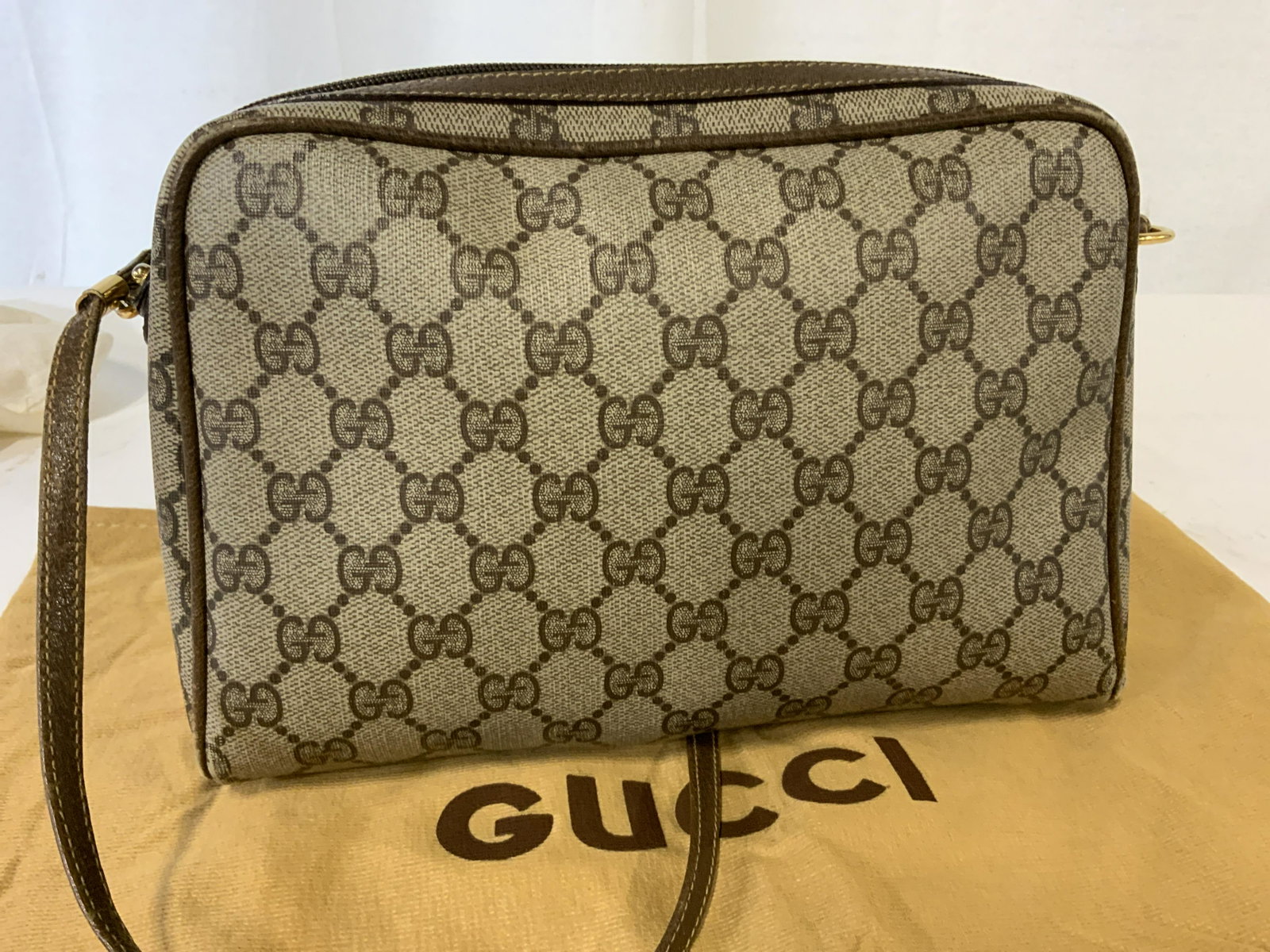 GUCCI CANVAS Vntg Monogram Shoulder Bag, Italy: Vintage GUCCI BAG, possibly c. Late 1980s or 1990s. Monogrammed GG on brown/ taupe canvas. Thin Leather strap, hangs 21 in. ( light wear to strap) . Gucci Zipper in gold tone. Interior suede, needs cl