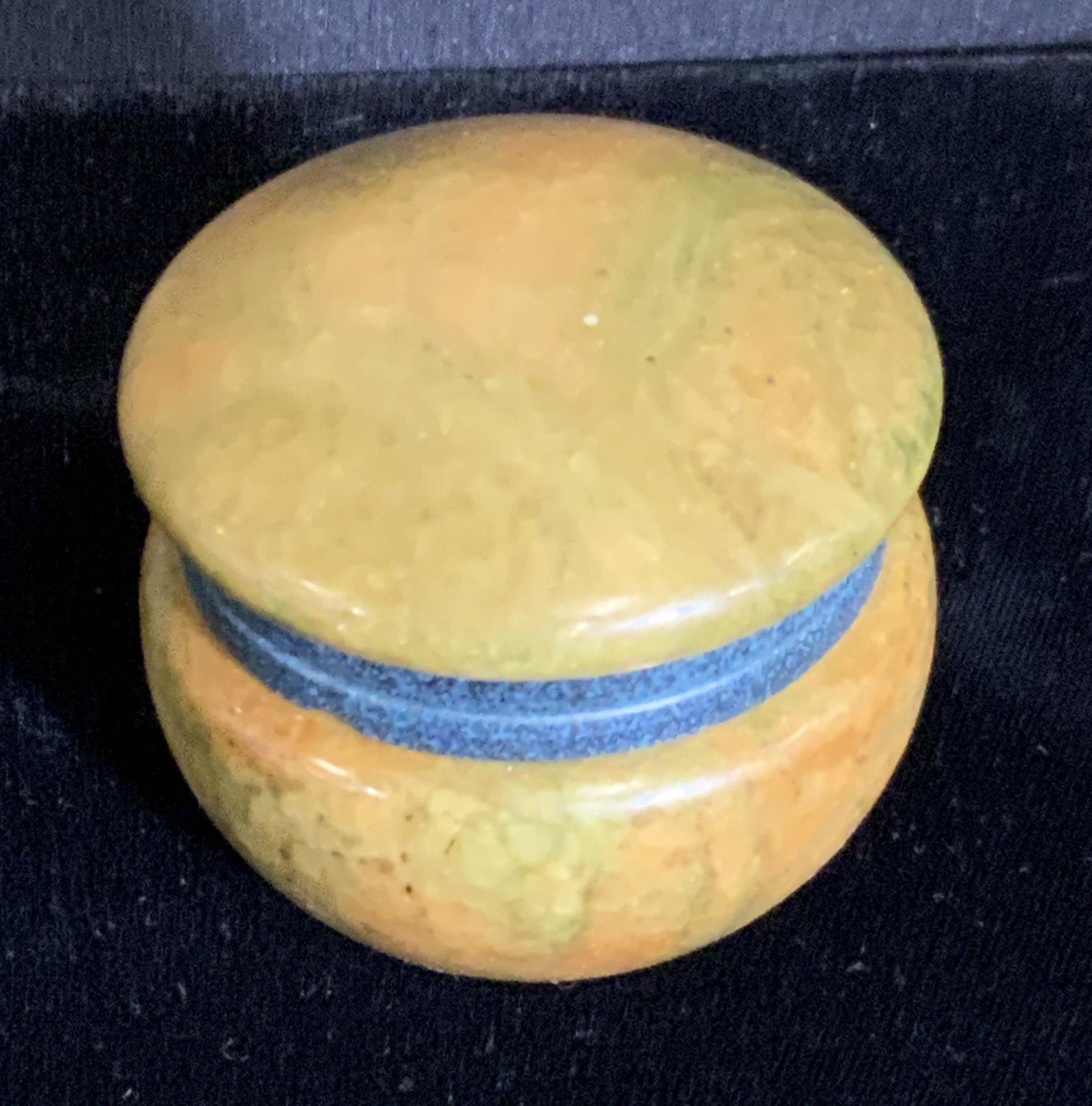 Vintage Hinged Composite Pill Box: Possibly stone hinged composite pill box. The hardware is a spotted blue. The pill box itself is yellow, green, and brown hues. Underside has sticker residue. Approx. Height 1.5 in. Approx. Width 2 in