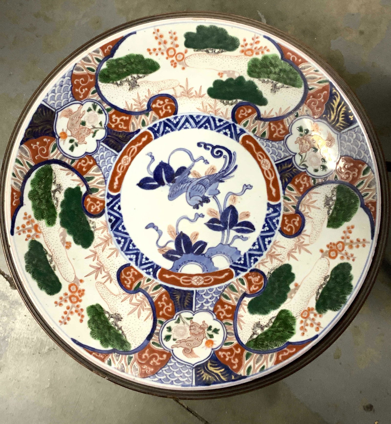 2pc Antq. Custom Made Table & Asian Motif Plate: A custom made dark wood table created for the purpose of holding this antique white porcelain plate. The plate fits in the center. The table has three feet. The plate is decorated with green, red, blu