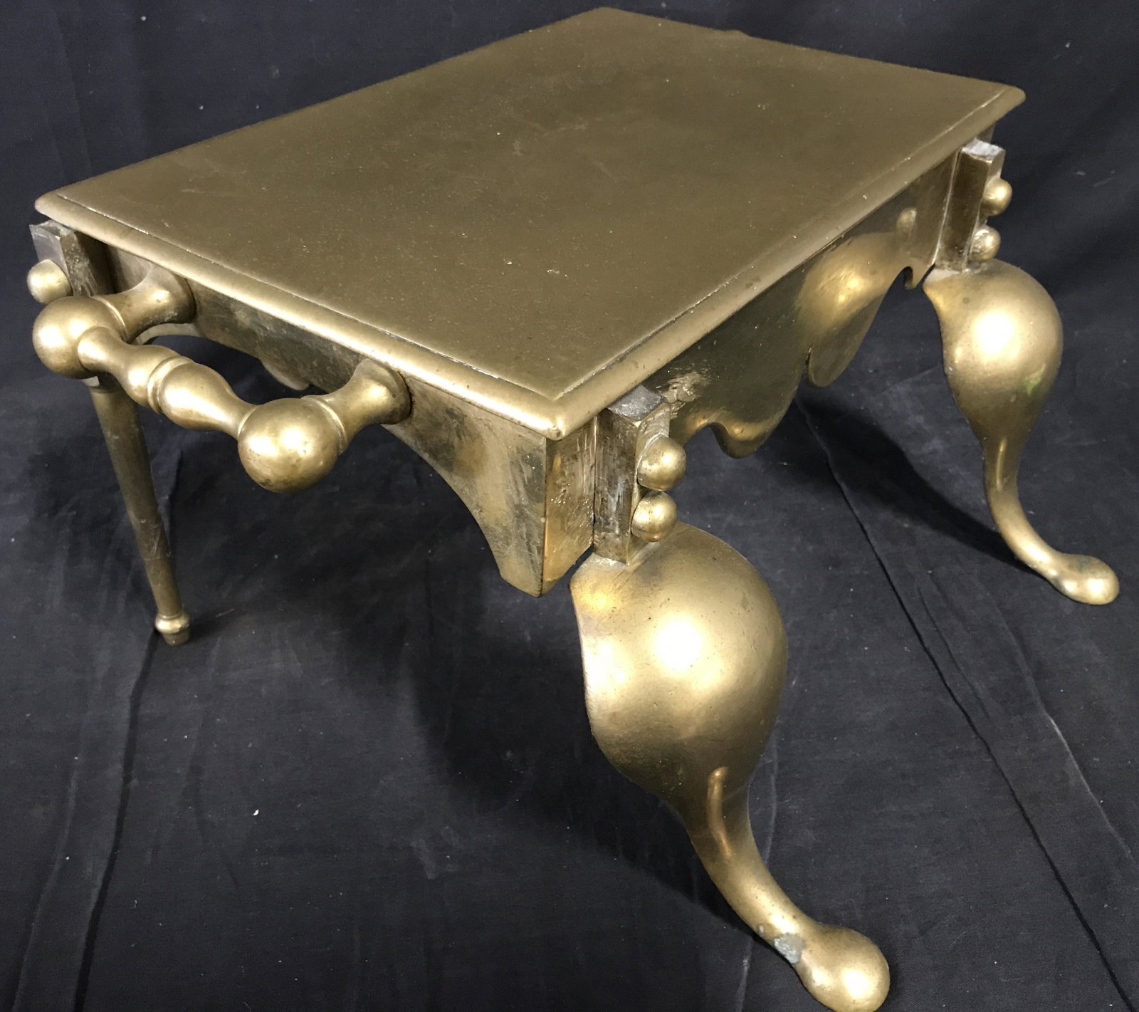 Antique Handled Solid Brass Fireplace Footman: Antique Handled Solid Brass Fireplace footman, no apparent signatures or stamps, Front two legs bolted onto piece slightly wobbly, evident oxidation to underside and hinges of bolts, footman is a Brit