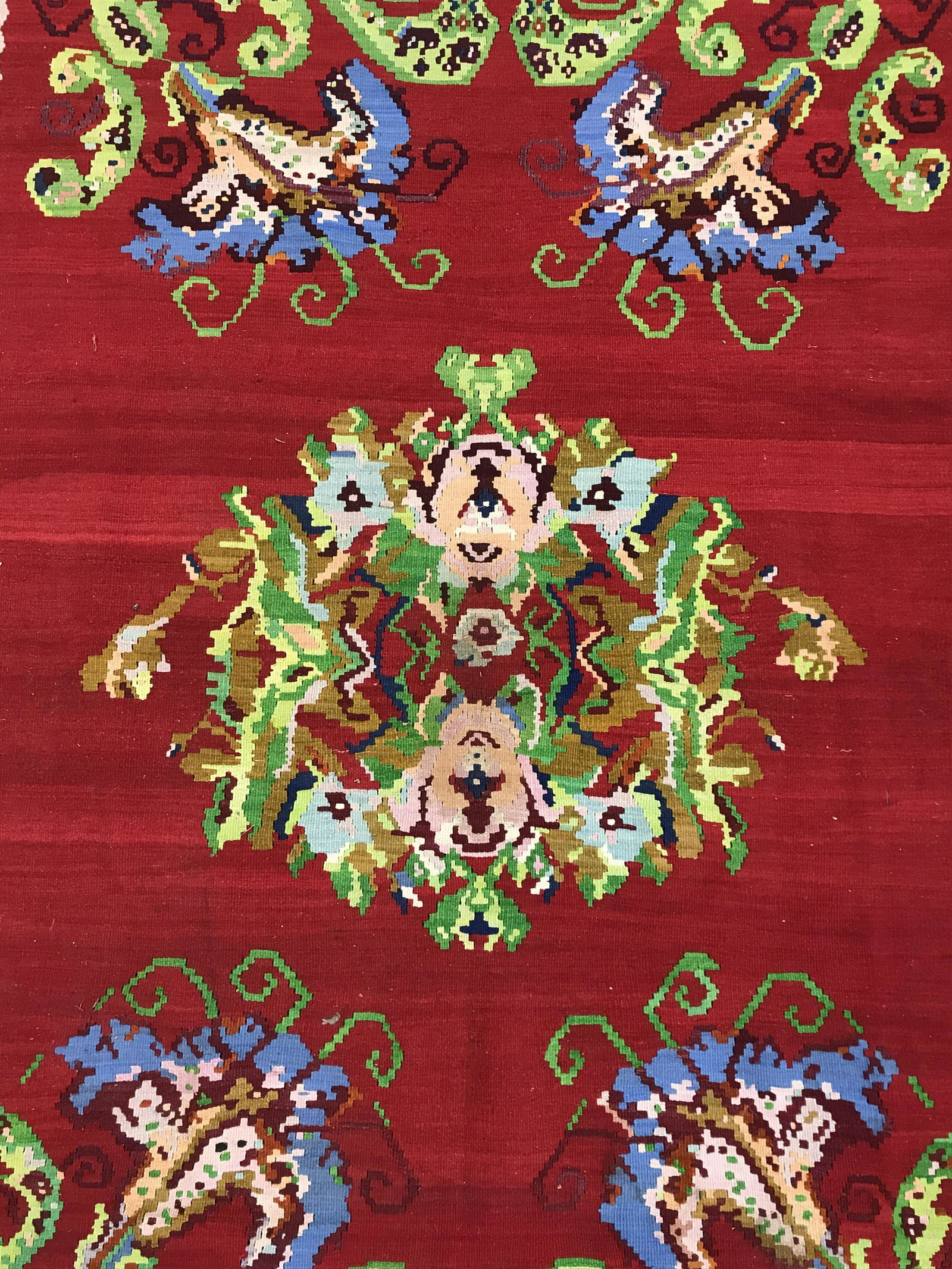 Vintage Fringed Wool Carpet, Turkey: Vintage Turkish area rug, handmade. Property alpine lake estate. Vibrant floral pattern colored in vibrant reds greens, and blue Tones. Tag on underside reads as VD NO 7485, HAND KNOTTED CARPET 100% W