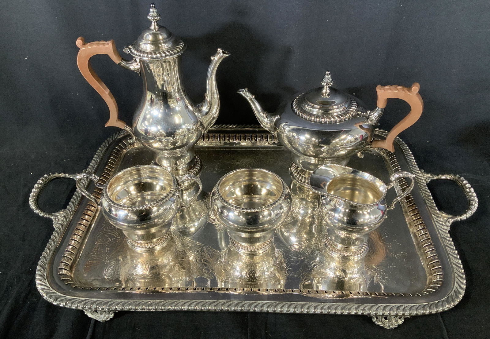 Lot 6 PS Co EP Silver Plated Tea Set: Lot 6 Trademarked Electro Plated Tea Set, Mark to base of tray reads ‘PS Co EP’, Inscription to base of tea set reads ‘16 Made in England’, cross and circle Mark to base, tallest teapot measur