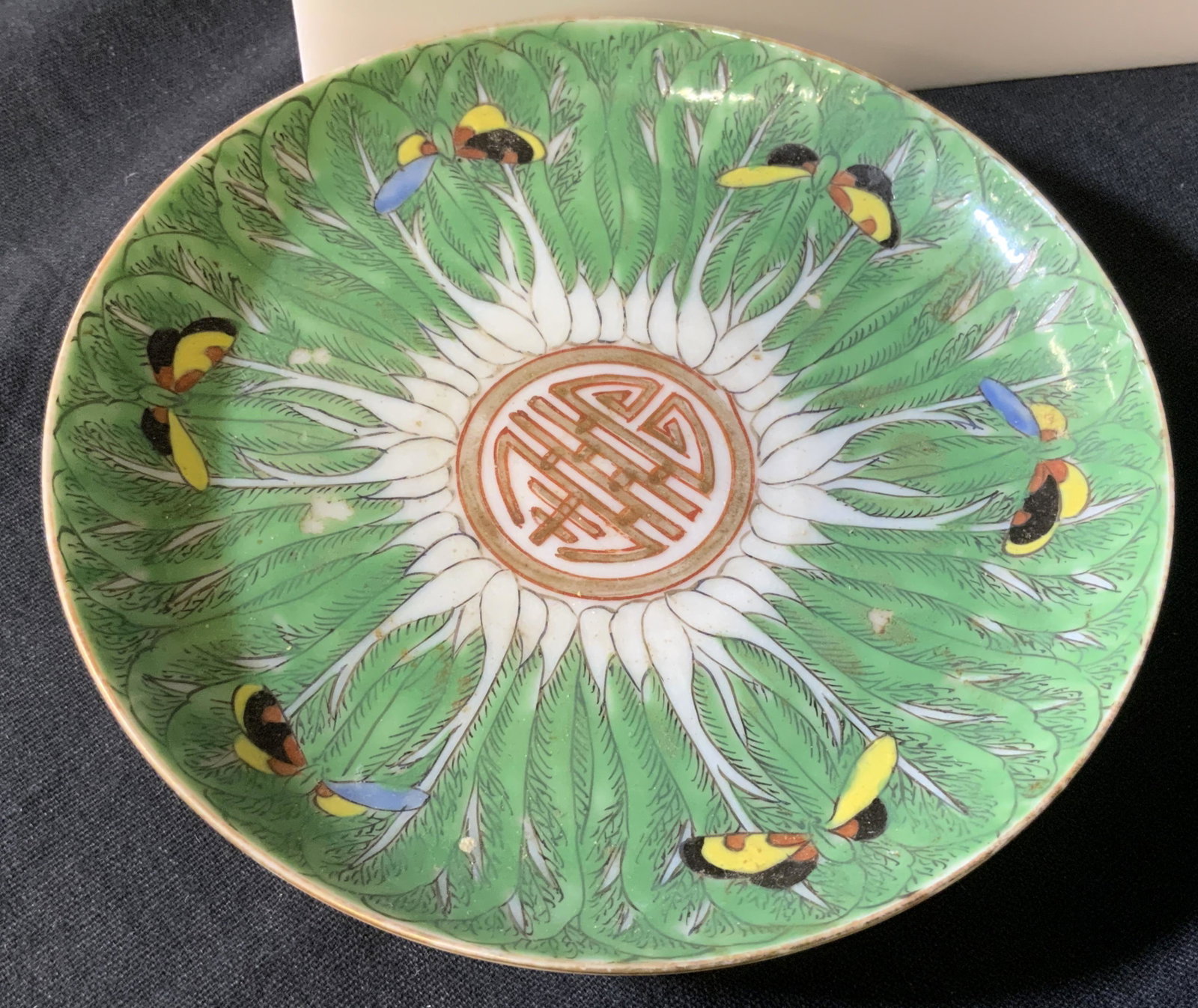 Vintage Asian TAOTIE Ceramic Decor Plate: Hand painted porcelain plate depicting large Green jungle leaves outlined In black with 6 butterflies on rim. Light ceramic paste pitting typical of vintage composition. No marks. Center Taotie medall
