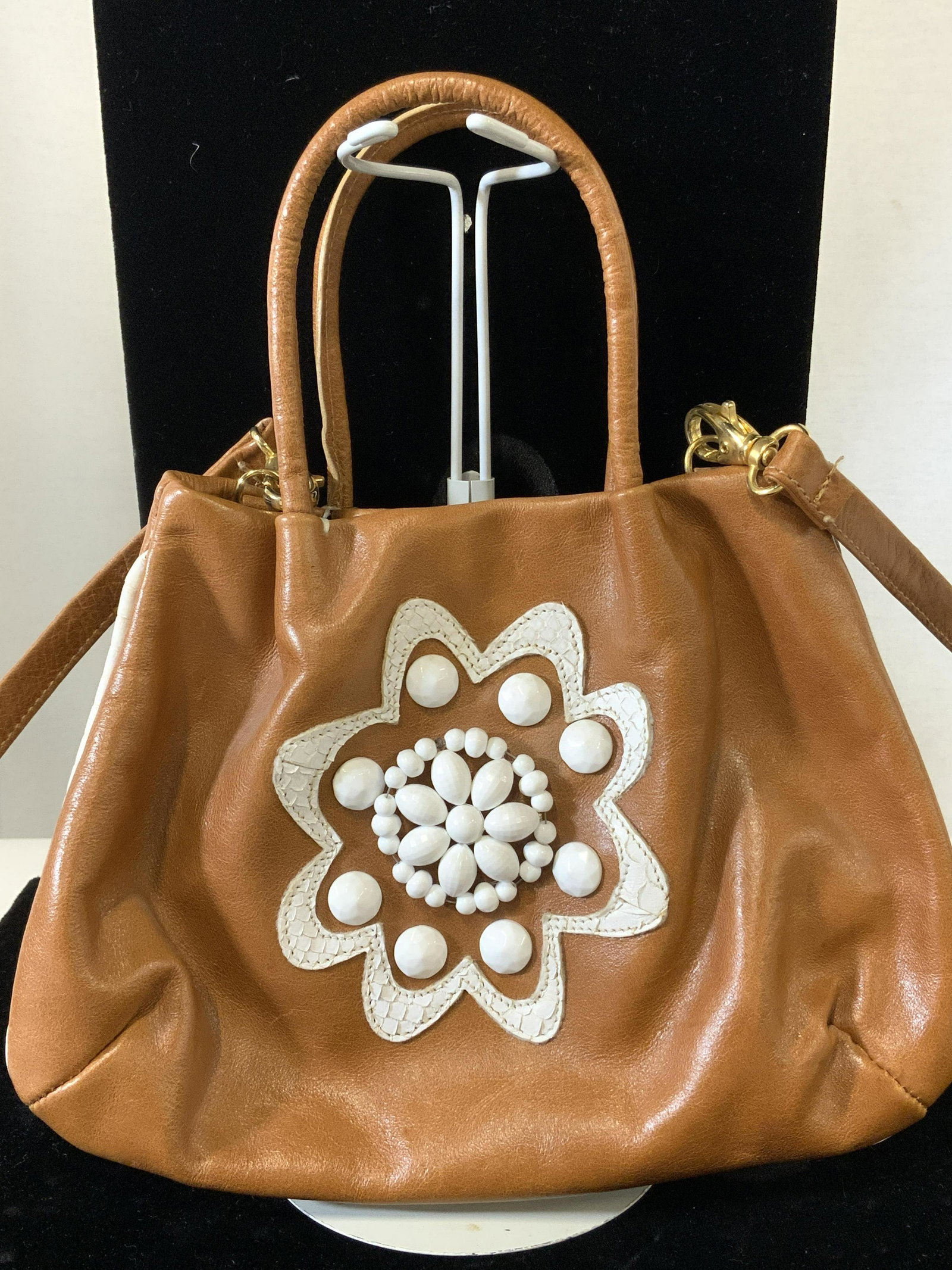 PULICATI Brown Leather Artisanal Bead Handbag: Designer Handbag, cross body and shoulder bag. Soft medium brown leather with cord handles. Detachable strap hangs 21.5 in. Additional front white beaded floral design with white leather floral medall