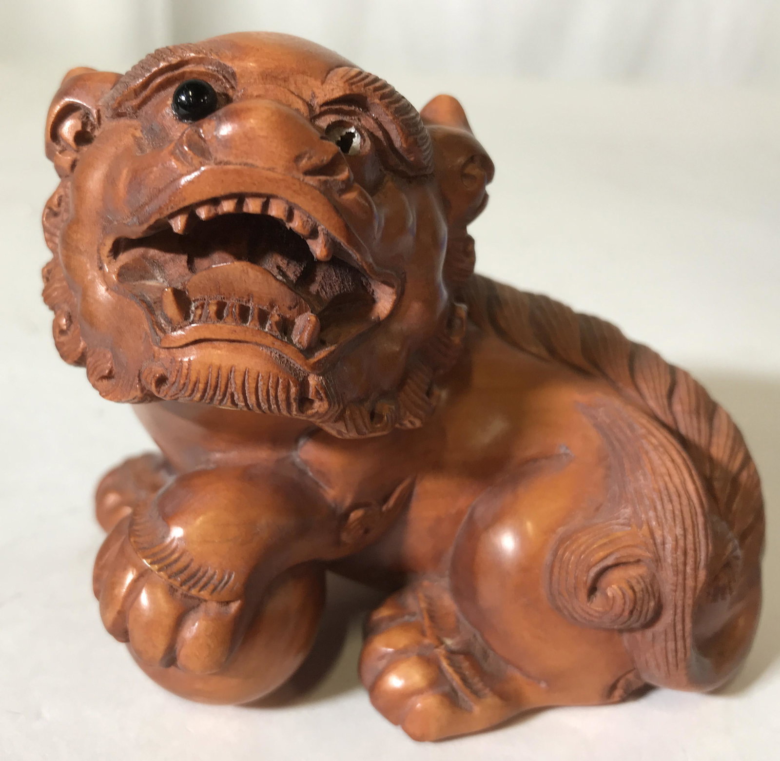Pair Signed Asian Carved Wooden Foo Dogs: Lot includes 2 foo dogs. Each are wooden. Each piece is signed with Asian characters. Each depicts seated temple lions. Each measures approx 4 inches long 3 inches tall and wide. Foo dogs, temple lion
