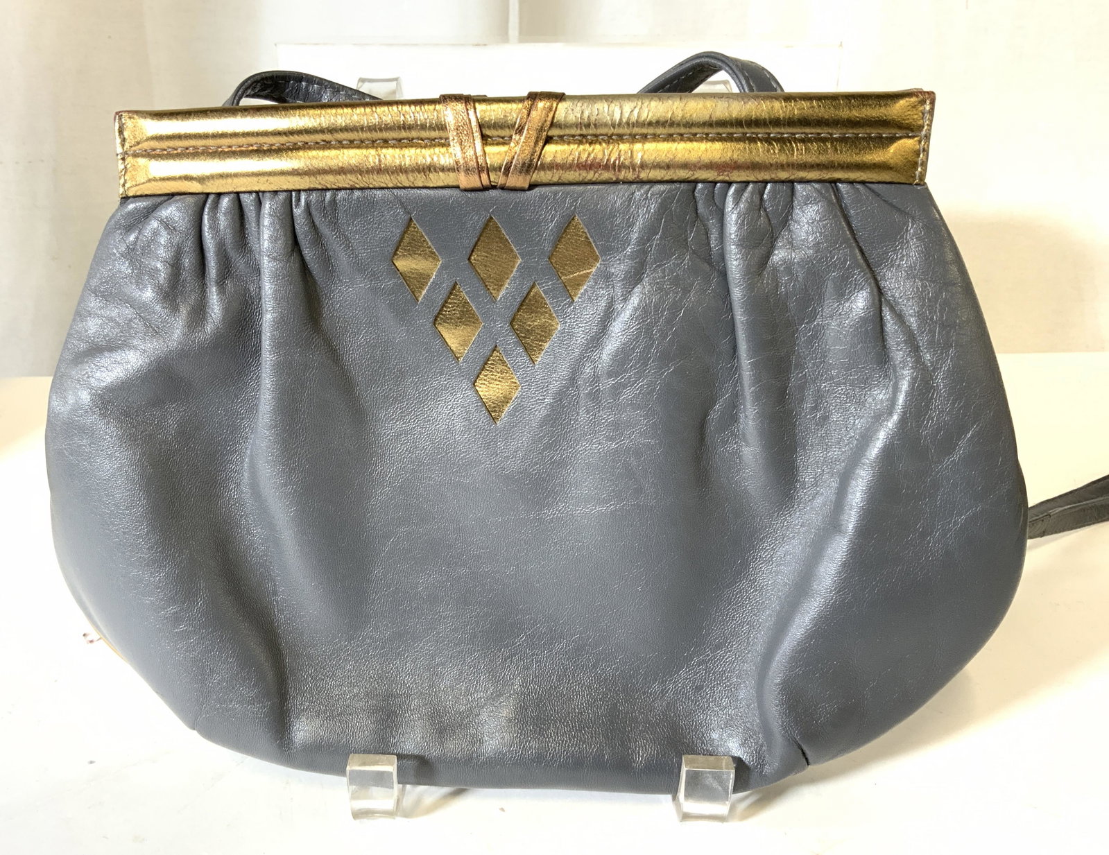 SCEPI Vintage Leather Shoulder Bag Purse, Italy: Vintage Scepi leather bag, reminiscent of 1980s with crescent shape. Grey with gold accents. Marked on sticker SCEPI MADE IN ITALY. Strap measures 22 in. 2 snap closure. Bag measures 11 x 8 in. Bag in