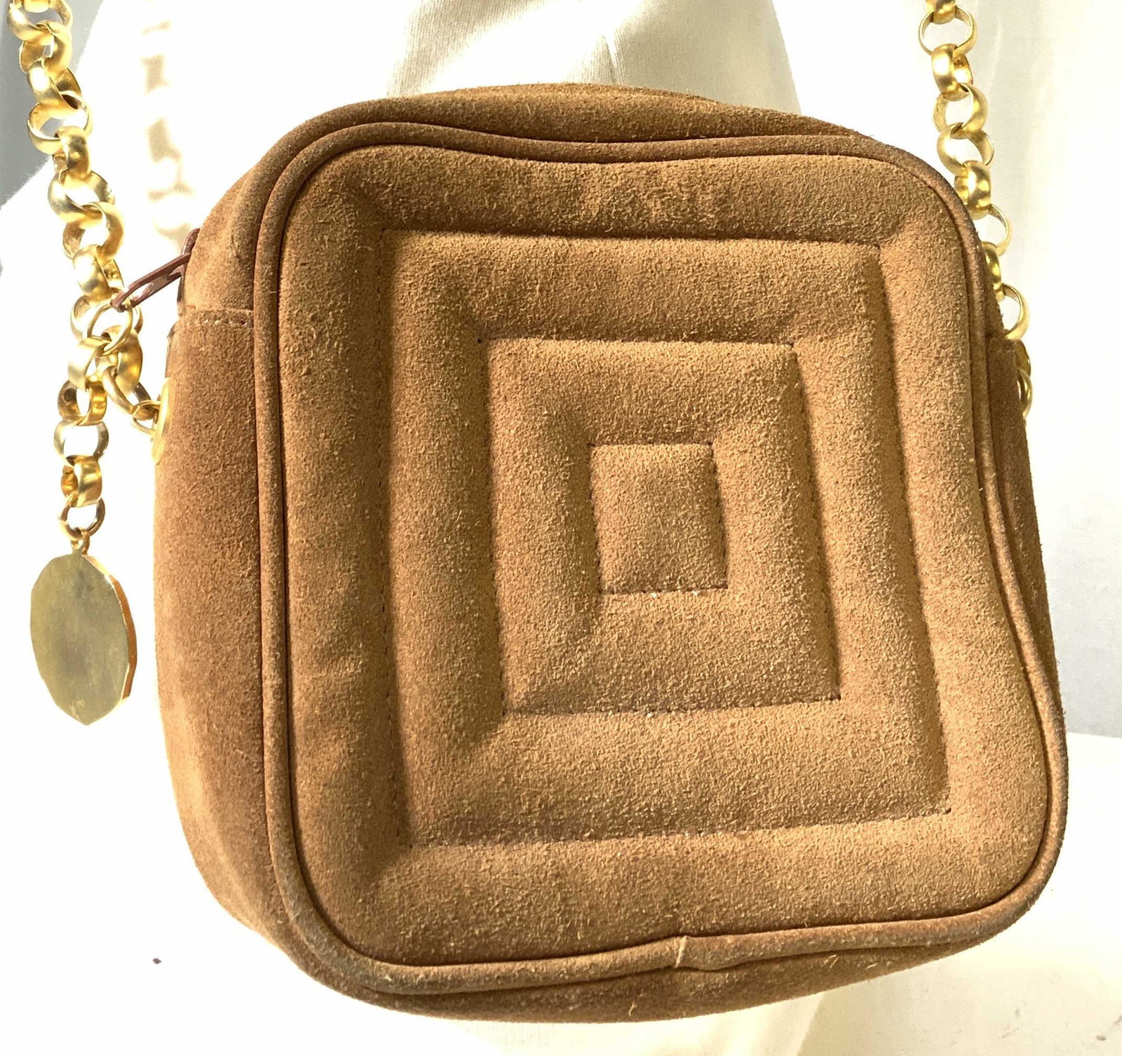 JAY HERBERT BY SHARIF Suede Purse, Shoulder Bag: Square suede bag, long strap with gold tone round links attaching to purse. Strap measures 20 in. Zippered compartment with designer logo lining. Accessory designer coin on zipper. Interior clean. Bac