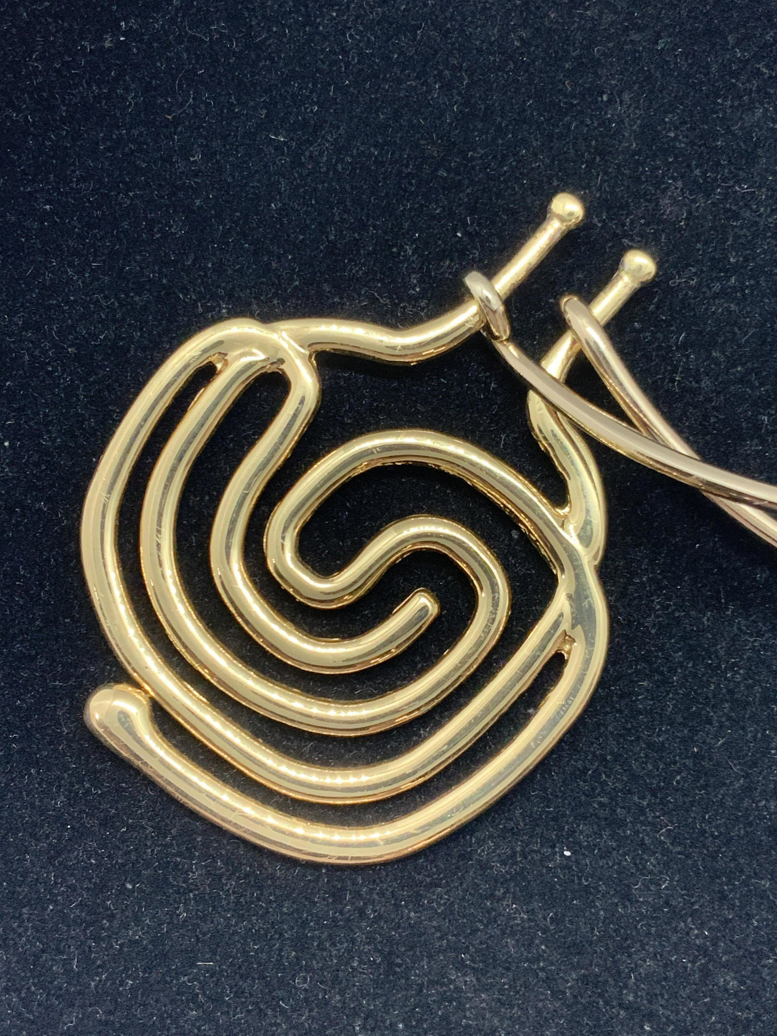 Spiral Pendant Choker Pendant Necklace Jewelry: Polished gold toned choker necklace with large spiral pendant in the center. The necklace has a decorative cuff closure. Approx. Diameter of necklace closed is 5 in. Approx. Dimensions for pendant are