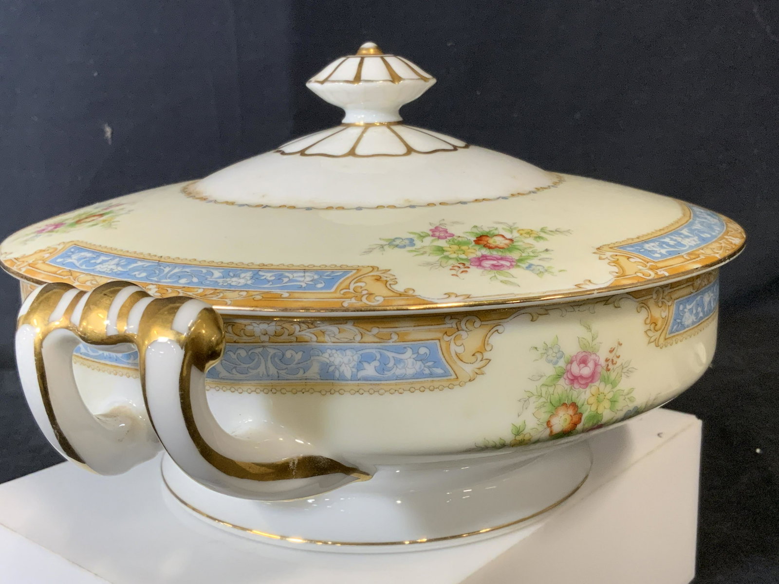 NORITAKE Hand Painted Porcelain Tureen, Japan: Gilt accented handles, lid finial and rim. Neoclassical shape, painted multi color roses. Possibly vintage. Trademark on underside reads NORITAKE Japan. 11 in wide, 5.5 in. tall. Porcelain Tureen, NOR