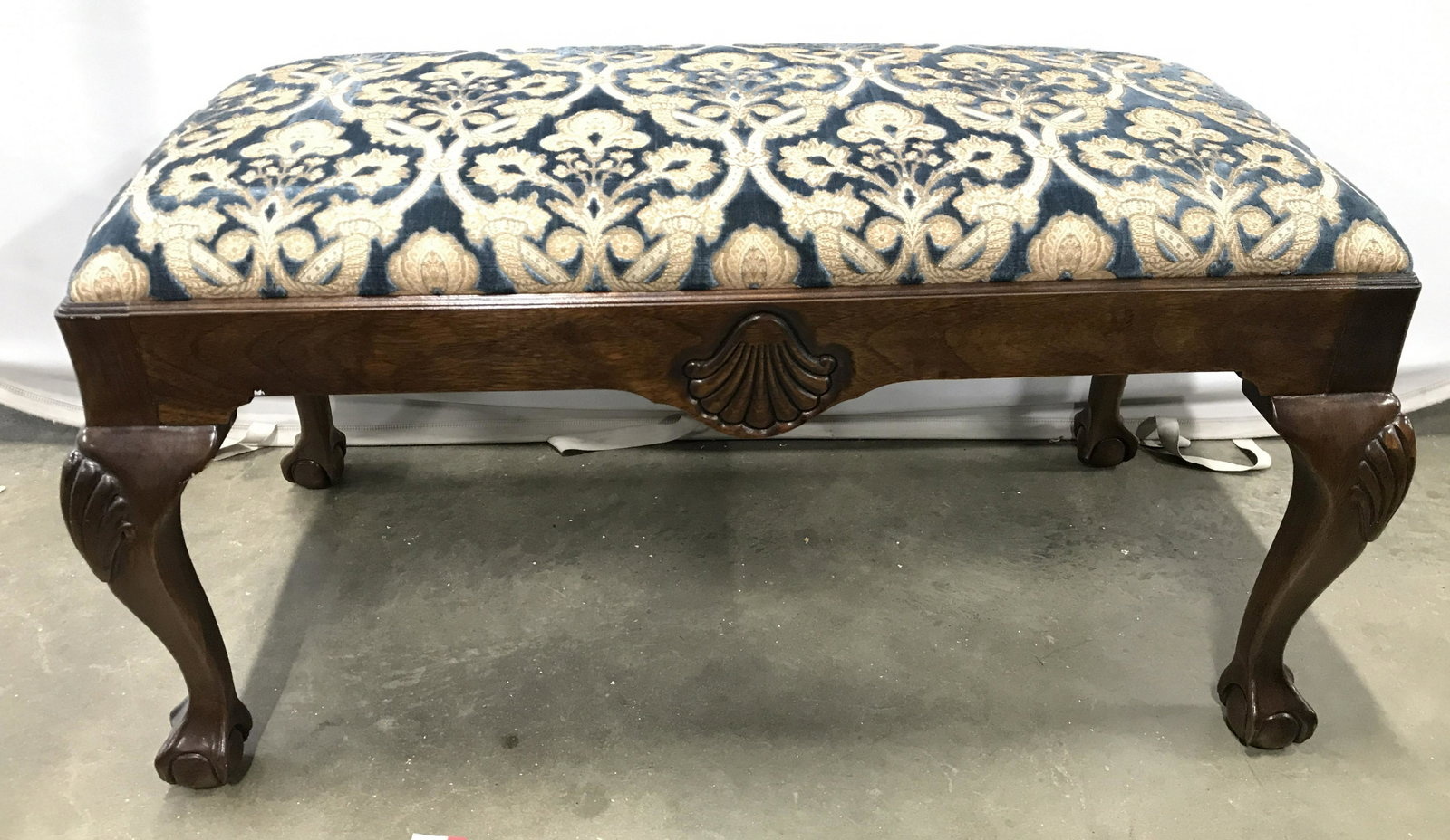 DREXEL HERITAGE Upholstered Carved Wooden Bench: Bench has tag on underside which reads DREXEL HERITAGE. Piece has ornately detailed upholstery on seat cushion. Piece has carved wooden ball and claw feet. Piece measures approximately 38 inches long 