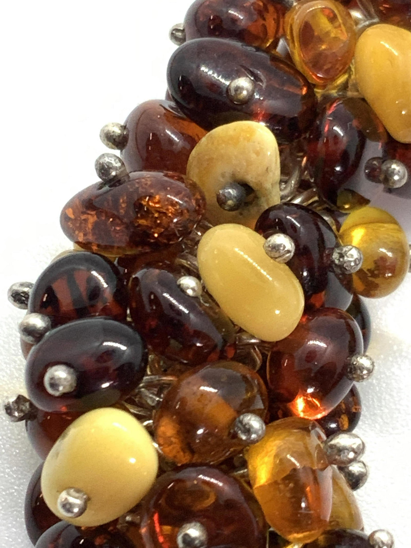 Vintage Amber Beaded Bracelet, Jewelry: Possibly Baltic Amber beaded bracelet with white and yellow hued stones throughout. The C-spring clasp is silver toned and the bracelet is adjustable. Each stone is unique in shape. Approx. Length 9.2