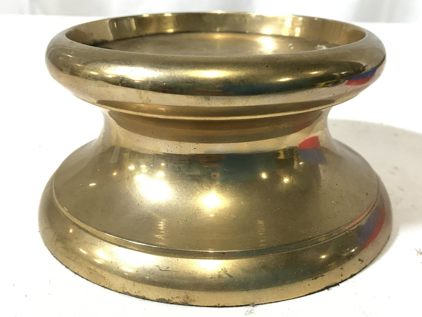 Gold Toned Brass Pedestal: Pedestal is gold toned and brass. Piece has circular shape. Piece measures approximately 5 inches wide 3 inches tall. Pedestal, stand, brass pedestal, gold toned pedestal, home decor. 6