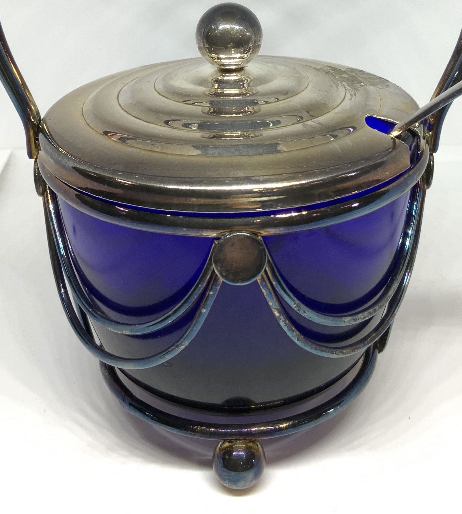 Vintage COBALT BLUE Glass Vessel in Metal Holder: 3 pcs total. Cobalt blue art glass vessel rests in a footed Silver plate metal carrier with handle. Finial lid and serving spoon. Use as sugar bowl, caviar bowl, condiment or appetizer serving vessel.