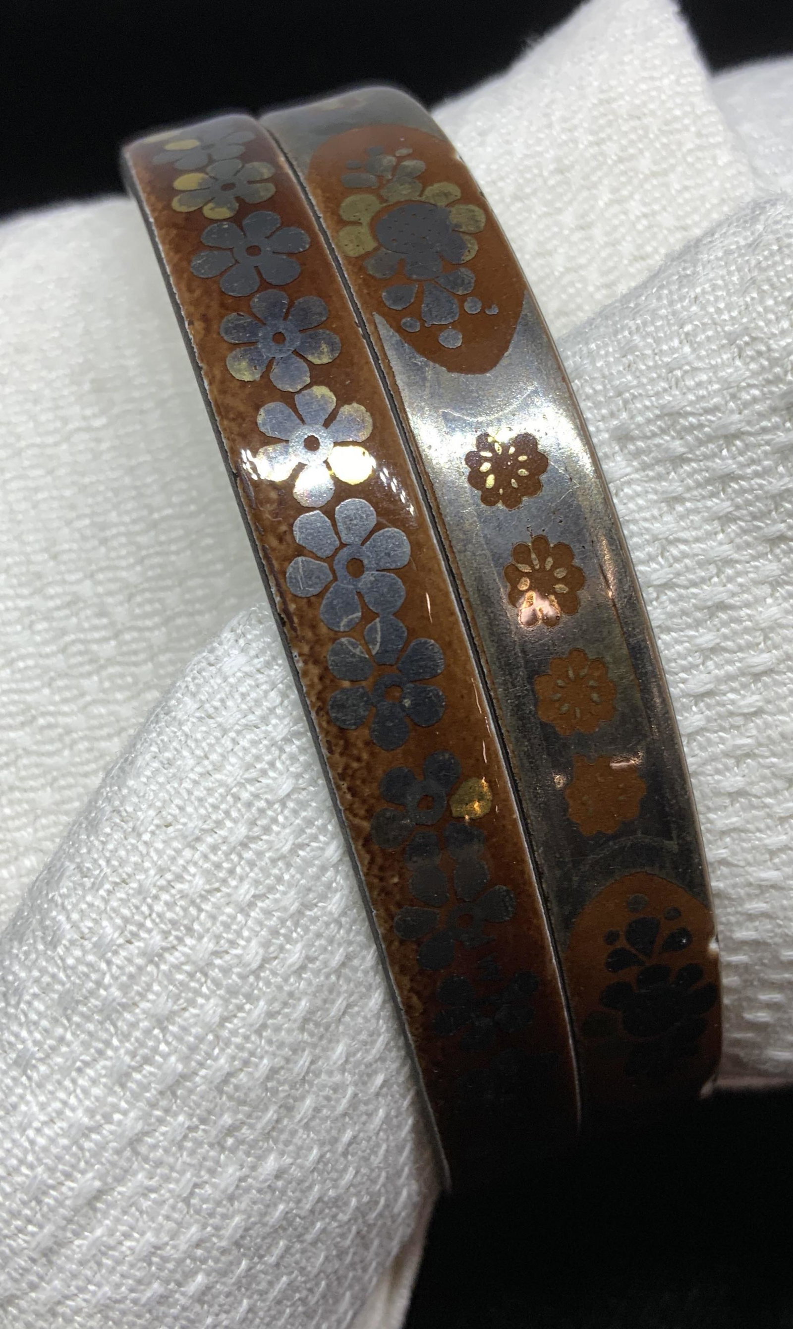 Signed MICHAELA FREY Enamel Bangle Bracelets: Pair. Silver toned and Carmel color enamel round bangles with 60s style daisy flower pattern. Both read MICHAELA FREY, 2 3/4 in diameter. Some wear to surface. Costume Jewelry, Fashion Jewelry, Bracel