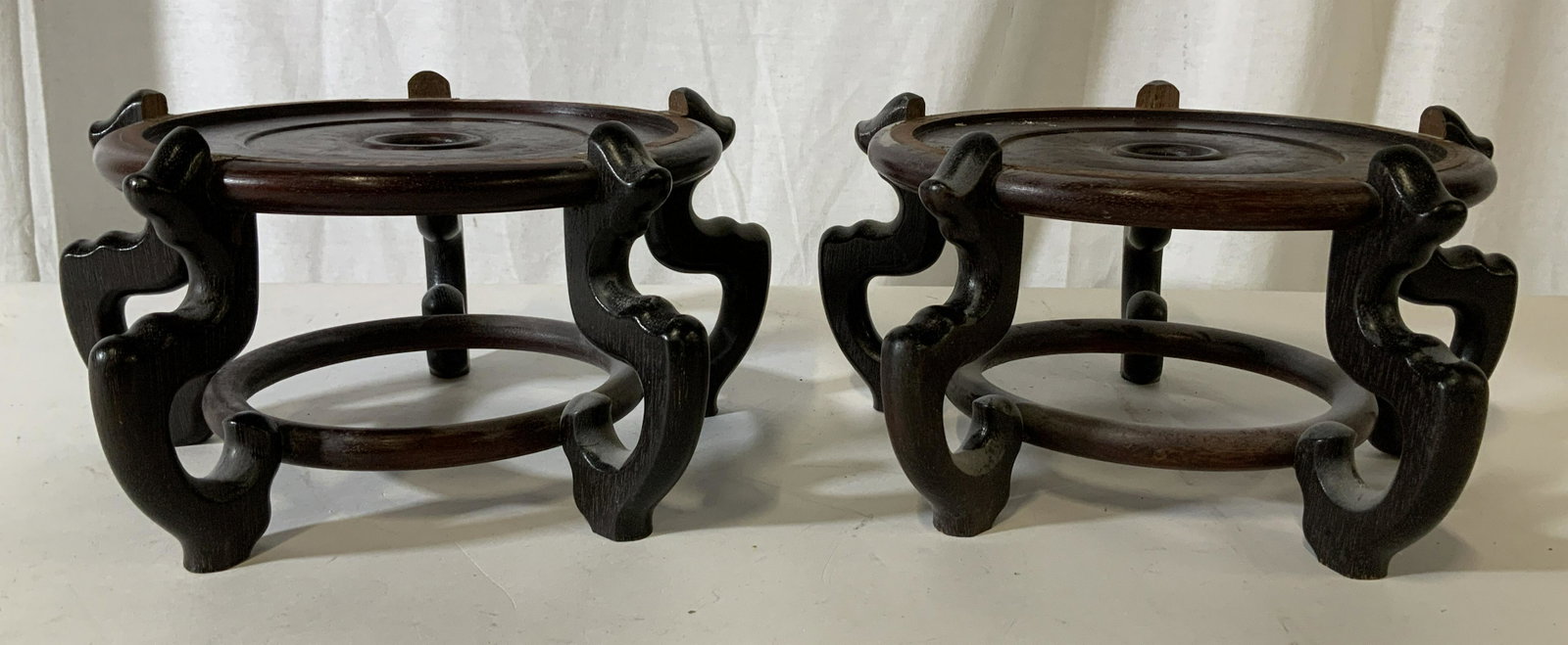 Pair Asian Wooden Vase Stands: Pair Asian Wooden Stands, no apparent inscriptions or labels, both measure 5 5/8 inches tall x 11 1/8 inches at widest point, one leg in one stand is loose but overall in good condition, Pair, wooden 