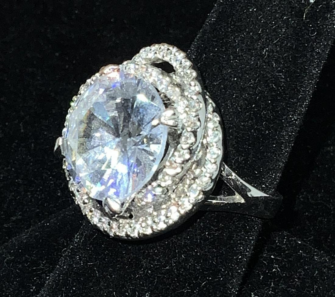 MONOR Oversize Crystal Cocktail Ring Jewelry: 15 mm round solitaire Crystal, prong setting with double wrap diamanté / rhinestone halo, all in silver tone metal. Sz 8. Total width 1 in. Rainbow reflection. Signed MONOR . Ladies Jewelry, Gifts, L