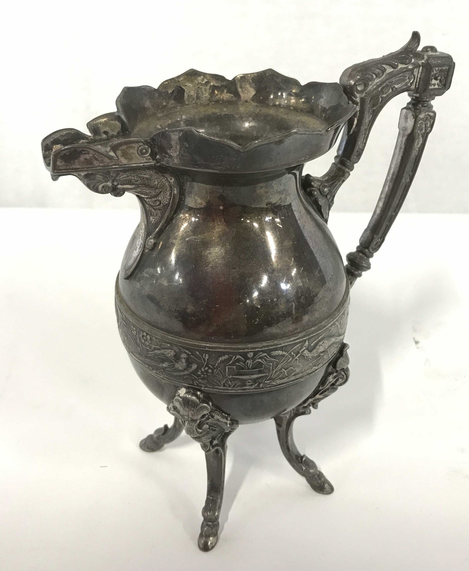 Vintage ROGERS & BRO Silver Plated Pitcher: Vintage silver plated pitcher. Body depicts several birds, perched on branches, and eating bugs. Pitcher rests on four legs, each leg is footed, feet resemble hooves. Measures approx 7.25 inches H, an