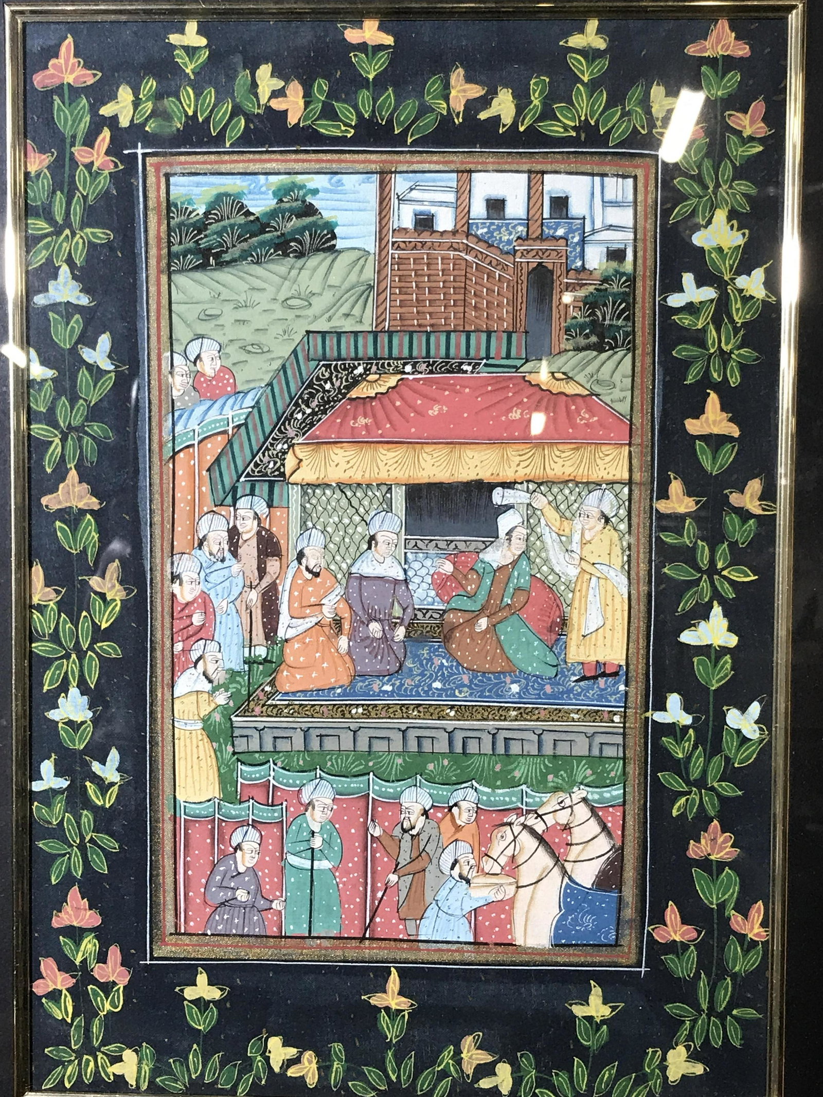 Middle Eastern Miniature Painting on Fabric: Middle Eastern Painting on Fabric, no apparent signatures or stamps, subject a group of men in a middle eastern outdoor tented setting, floral painted border, matte black border, gilt wood frame, meas