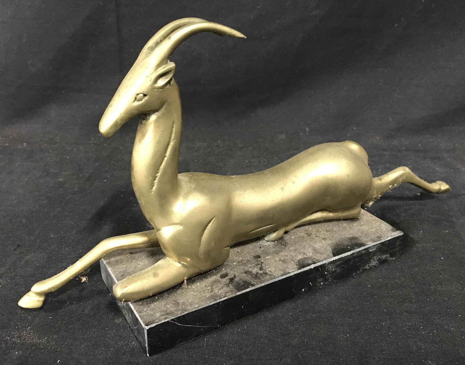 Art Deco Style Gazelle Figural, Taiwan: Art Deco Style gazelle style, possibly vintage, affixed to a carved stone base. Measures approx 6.25 inches H, 15 inches W. Label on underside reads as MADE IN TAIWAN. Wear is consistent with age and 