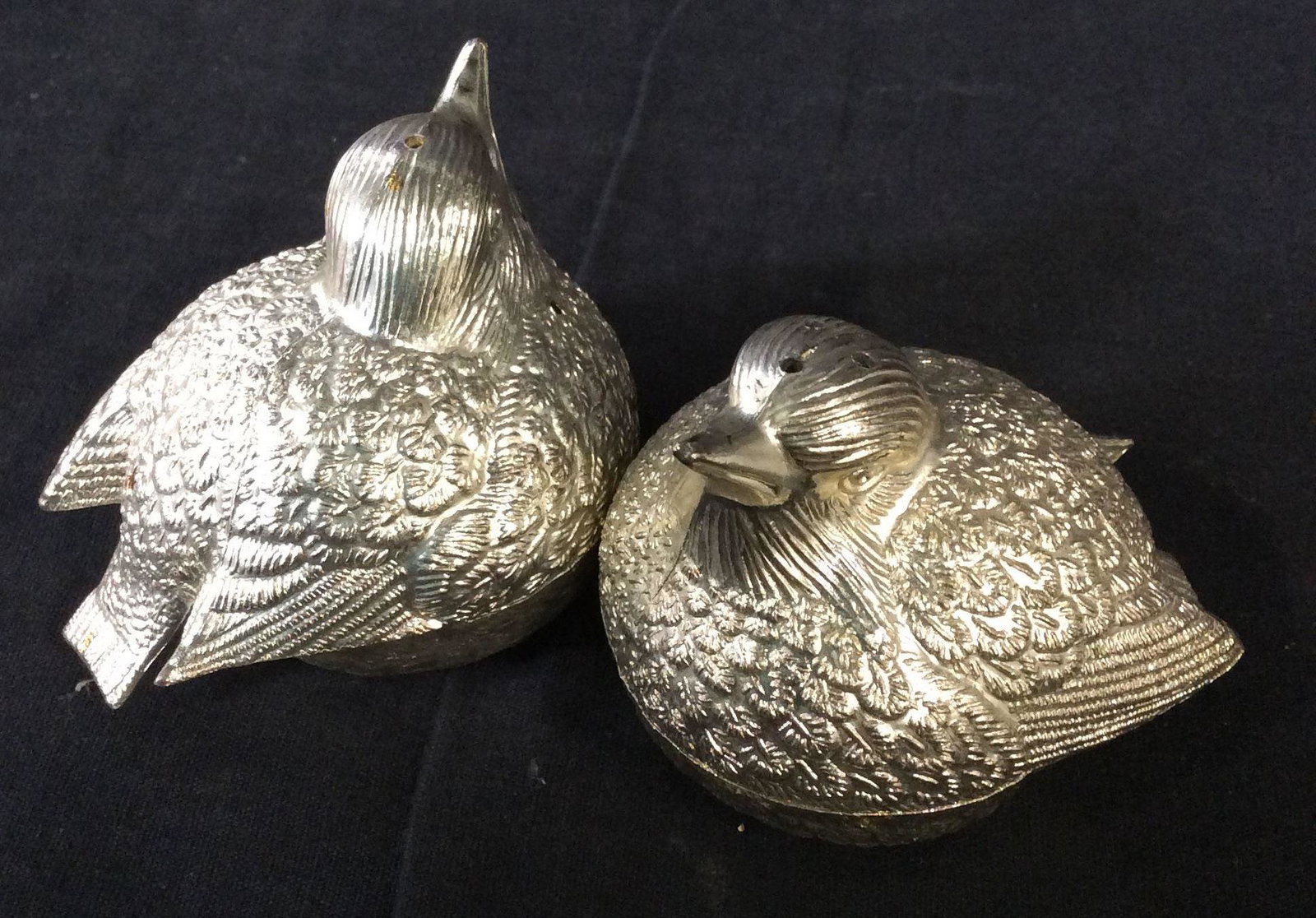 Silver Toned Bird Salt & Pepper Shakers: Embossed Metal Bird, possibly sparrow, salt shaker has 3 holes, pepper shaker has 1 hole. Both with removable plastic plug. 3 in. long, 2.5 in ht. Tabletop Kitchenware, Salt & Pepper Shakers, Bird Fig