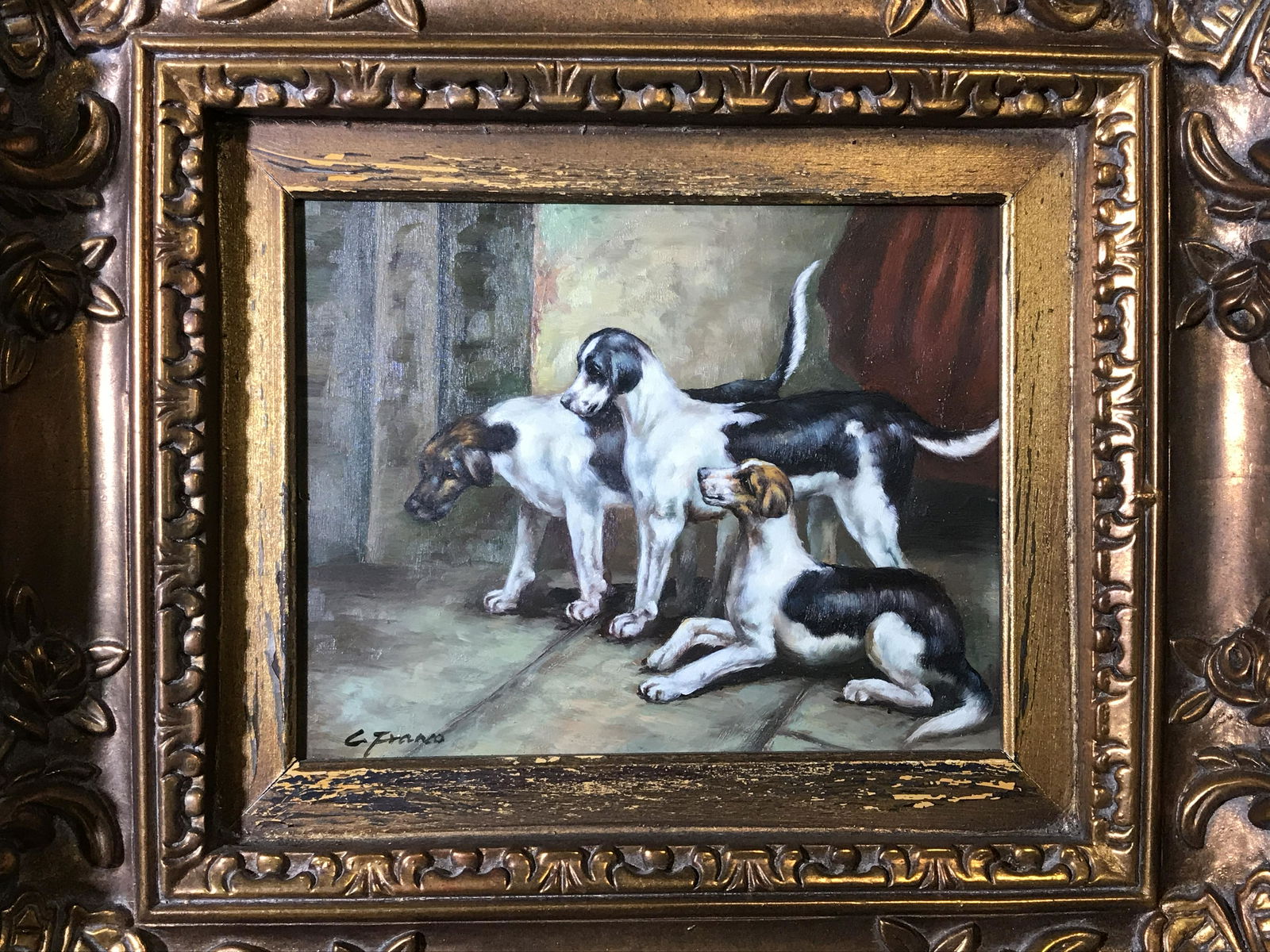 Signed Oil on Board Painting of Dogs: Signed oil on board painting of dogs, signature to the lower left corner reads ‘G. Frano’, subject three dogs together in a room, highly ornate hand carved gilt wood frame, some chips to frame, me