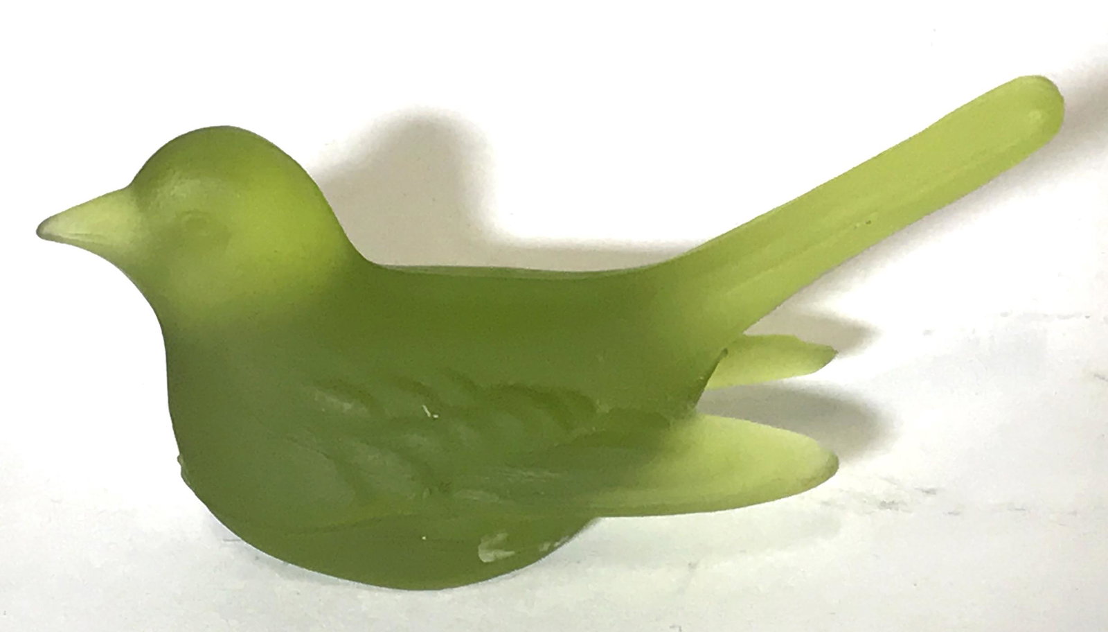 LARSON Art Glass Crystal Green Bird figural: Larson Crystal Green Bird, label to underside reads ‘Crystal Larson USA Made’, subject a small green crystal bird with wings in and back, measures 3.5 inches at longest point and 1.5 inches at tal