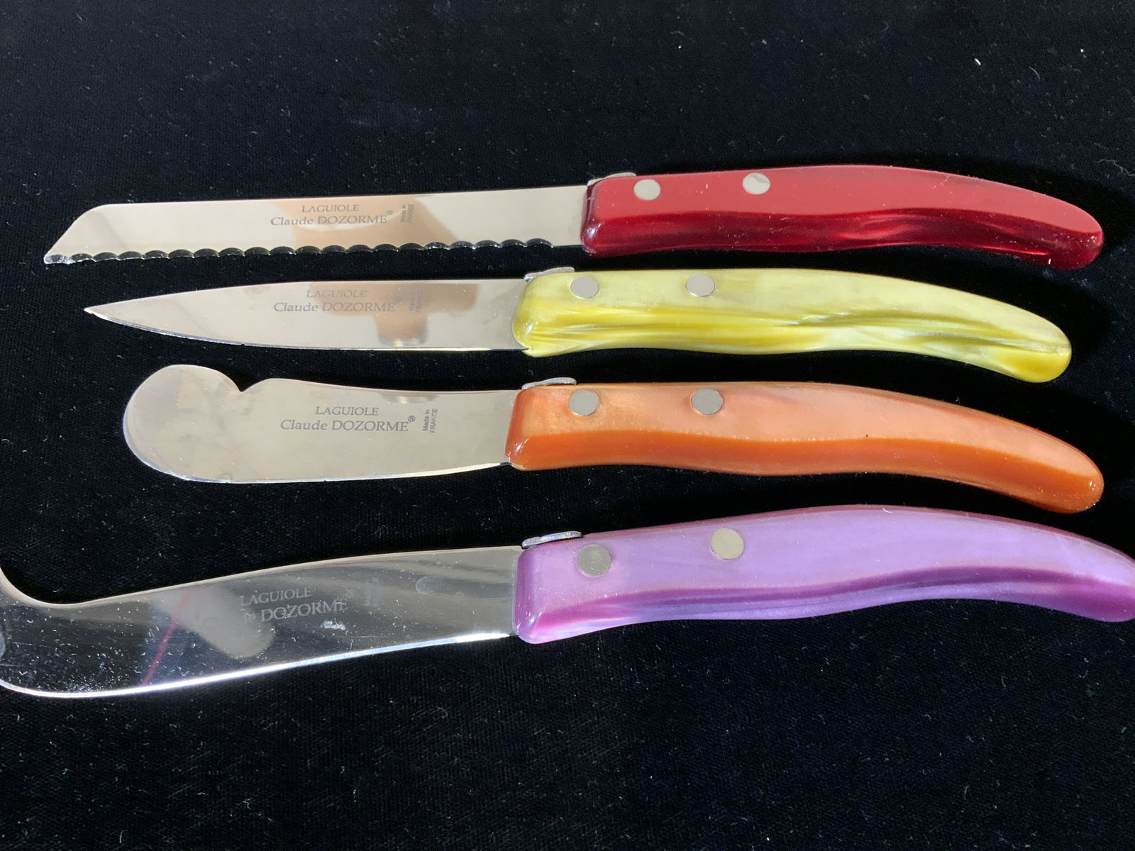 CLAUDE DOZORME CHEESE Knife Set, Org Box, France: 4 piece knife set with different blades for different types of cheeses. Colorful resin handles, all blades trademarked, read ‘ LAGUIOLE CLAUDE DOZORME - Made in a France’ Come in natural wood box 