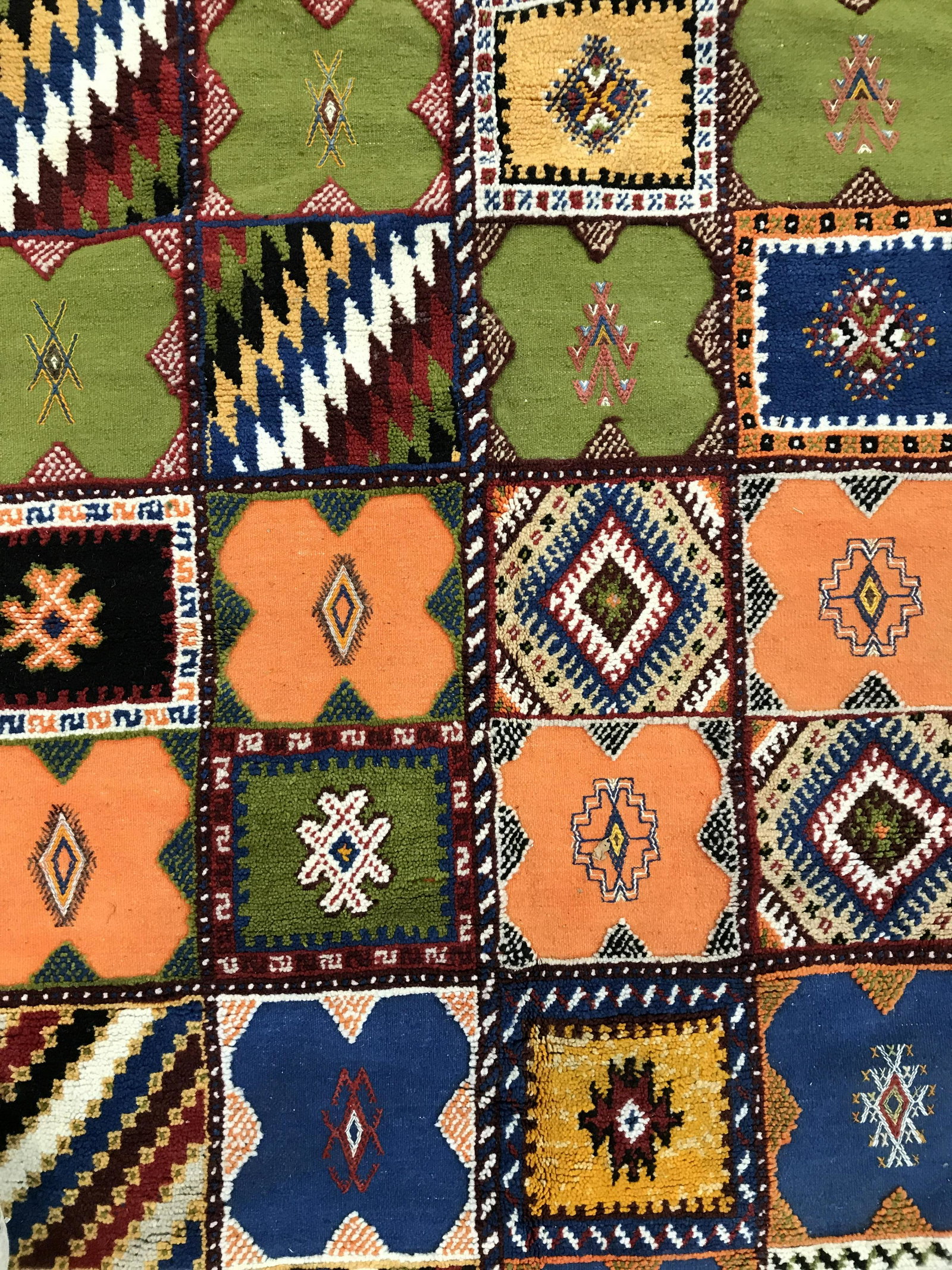 Vintage Handmade Multi Square Wool Rug: Rug is wool and handmade. Piece is vintage possibly antique. Rug has variously designed square areas with multi toned geometric detail. Piece is Fringed on one side. Some areas of rug have Raised wool
