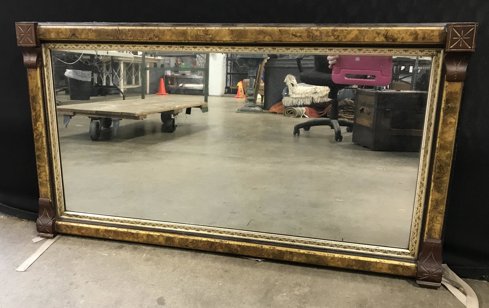 Vintage Multi Toned Wall Mirror: Vintage, multi toned mirror, possibly antique. Frame is wood, carved, and detailed with gilt paint. Silver toned geometric patterns run along mirrors edge. Measures approx 25 inches H, and 44.5 inches