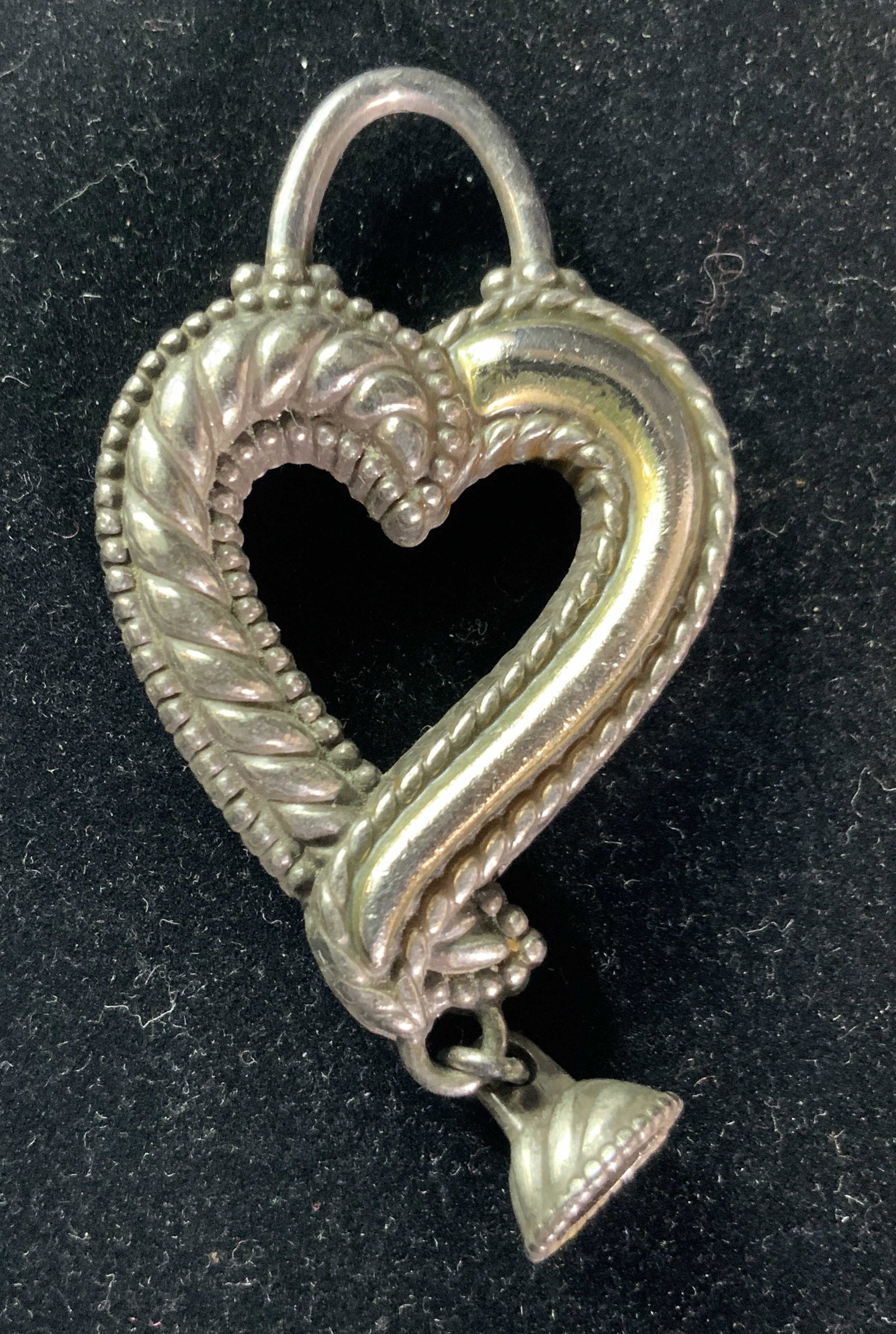 Heart Form Etched Metal Pendant, Jewelry: An etched metal heart form pendant with a bail. One half of the heart is polished, light gold tone color. Approx. Length 2.25 in. Approx. Width 1.5 in. Pendant, heart, metalwork, metalware, Ladies Jew